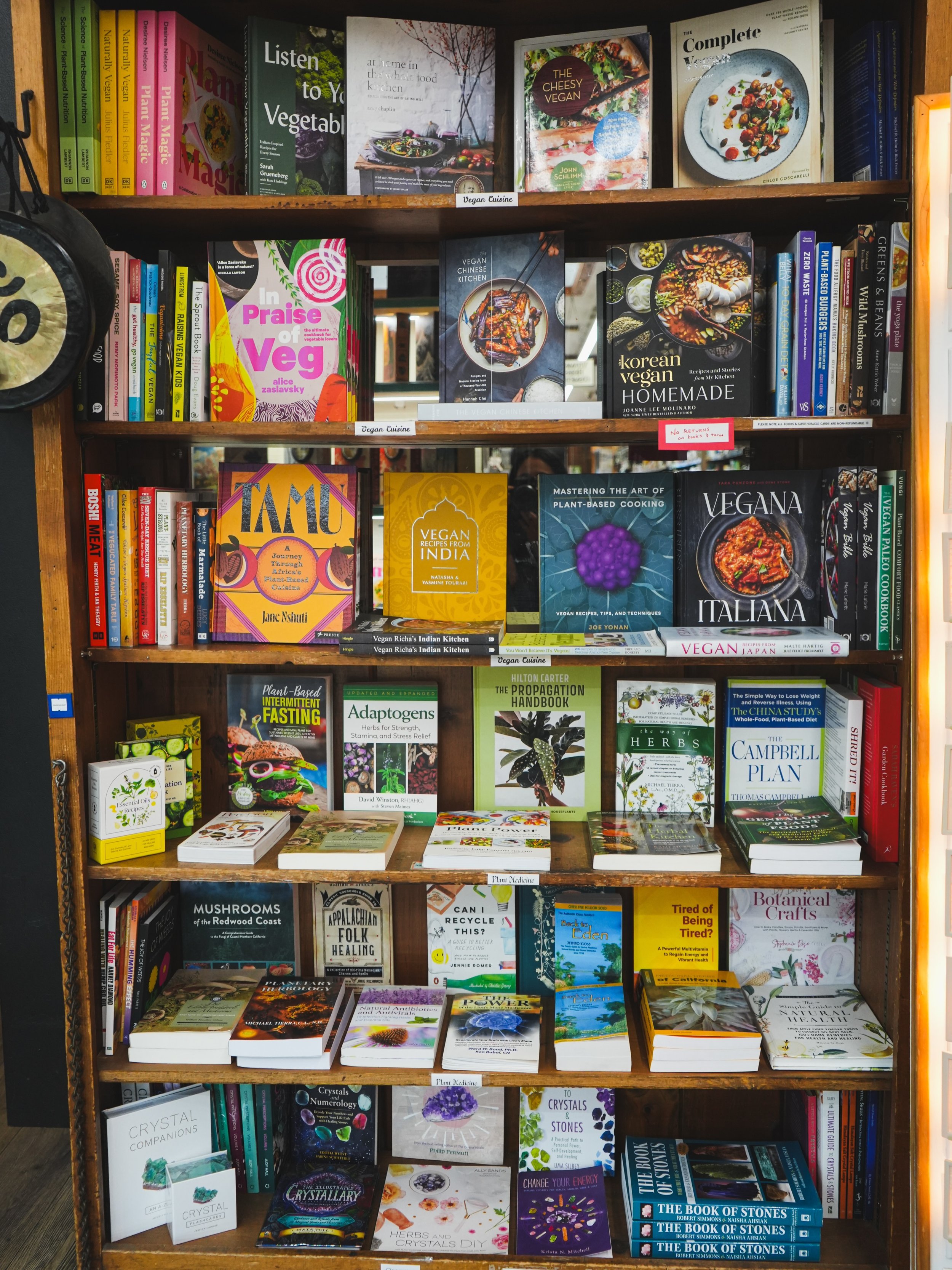 A look at our book section 😍 Travel through the (culinary) world this summer ☀️ through one of the many wonderful plant based cookbooks we have on our shelves! 🌎👨🏻&zwj;🍳👩🏾&zwj;🍳🍽️🌱