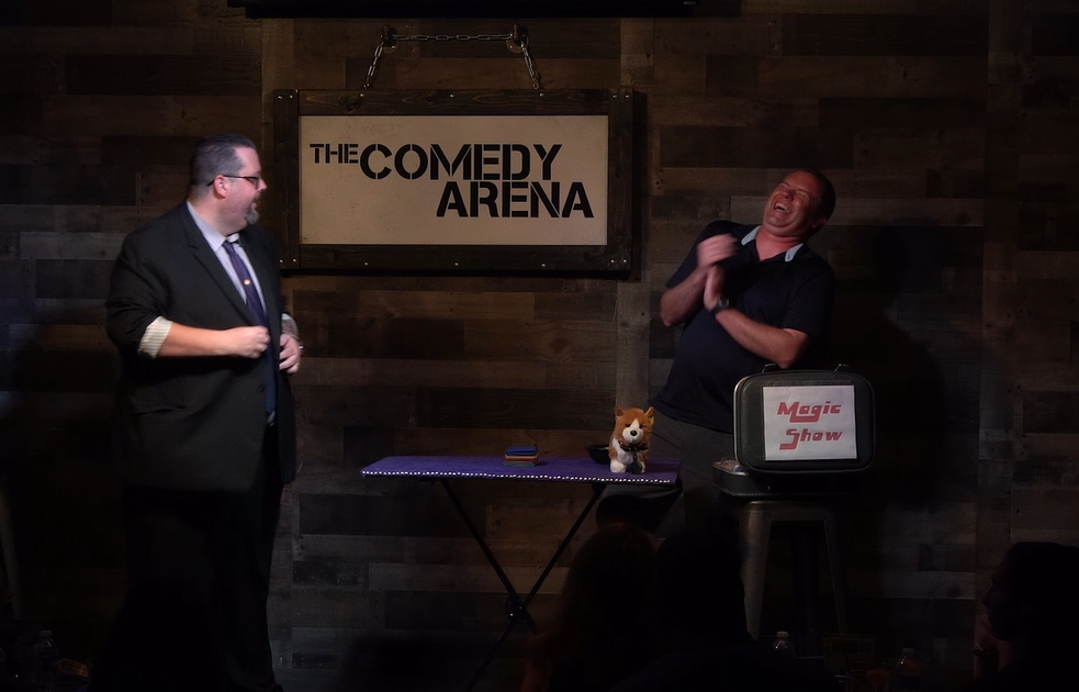 Jeff Walsh making a volunteer laugh on stage as he performs his comedy and magic show at the McKinney Comedy Arena