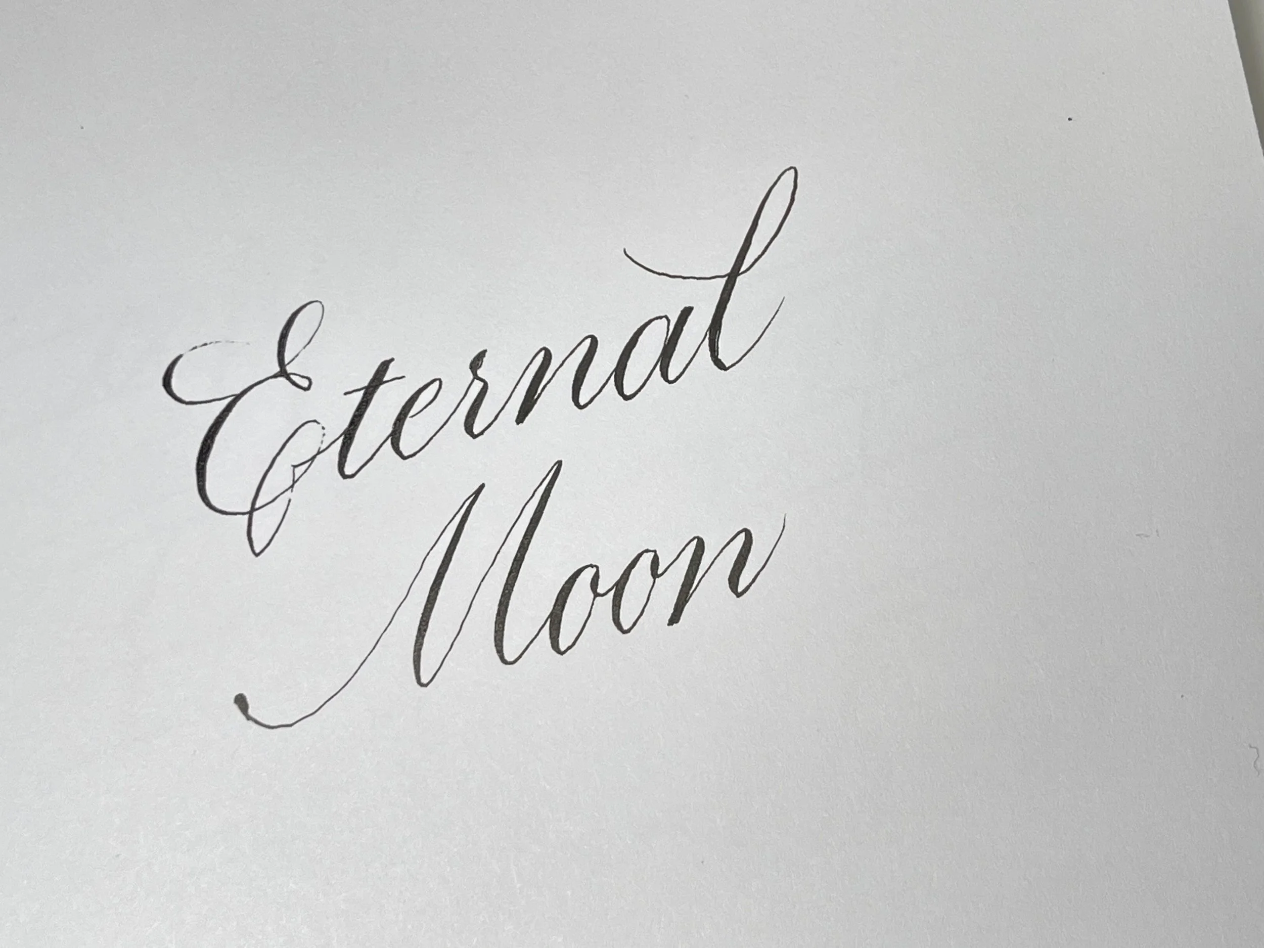"Eternal Moon" written in black ink