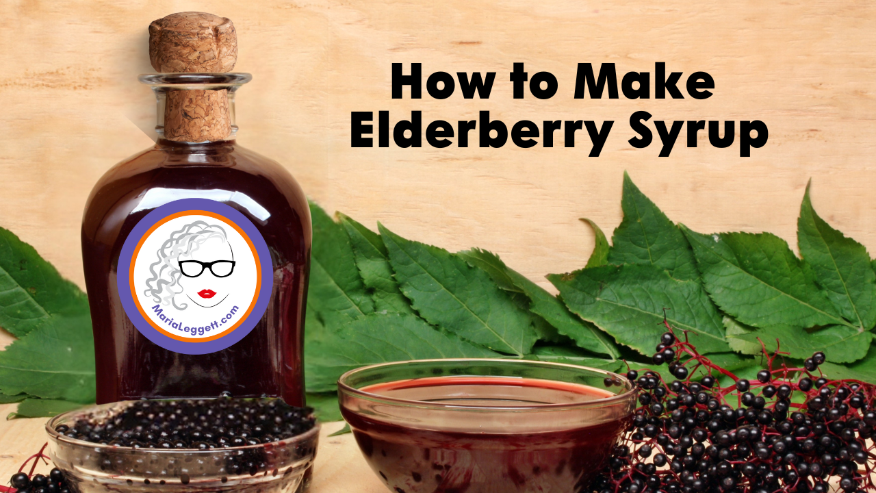 A bottle of elderberry syrup, a bowl of elderberries, a bowl of elderberry syrup, and elderberry leaves with black elderberries on a wooden surface, with the text "How to Make Elderberry Syrup".