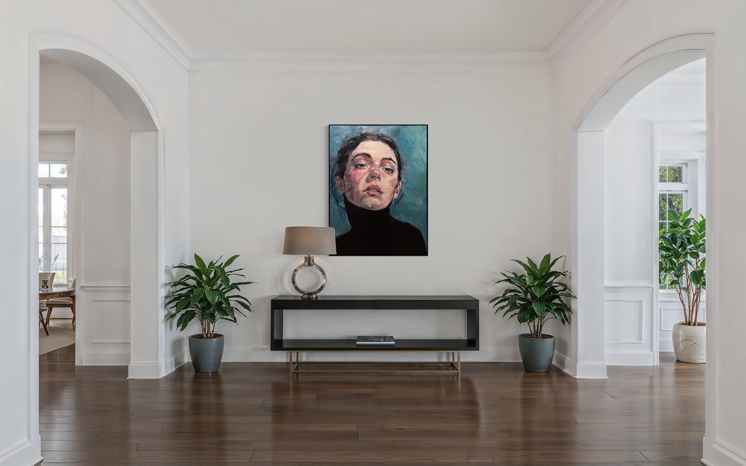 A modern dining room with a black oval table, six chairs with beige seats and backrests, and two green chairs with black frames. The room has white walls with decorative wainscoting, two windows with arched tops and gray Roman shades, wall-mounted white sconce lights, and a colorful abstract painting hanging on the wall between the windows. The floor features a herringbone wood pattern.