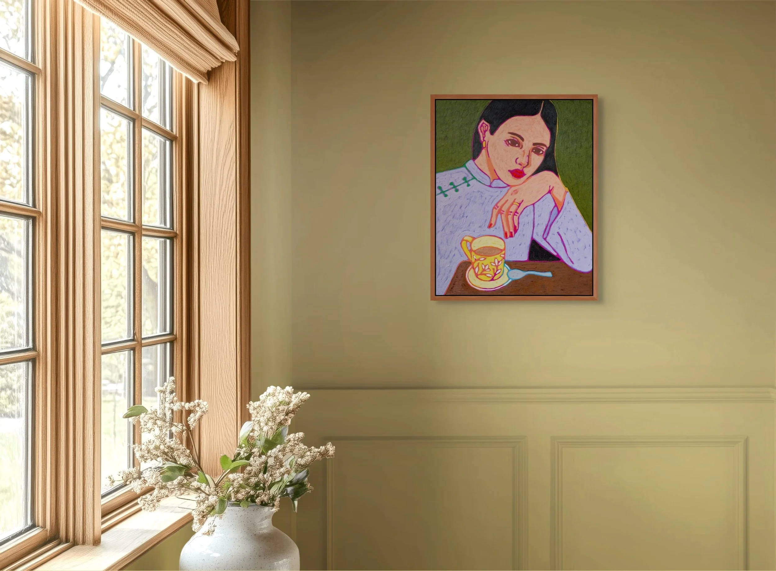 A yellow wall with a framed colorful portrait of a woman with dark hair, resting her head on her arm, with a yellow cup and spoon on a table in front of her. A window with wooden trim and a white vase with white flowers are also visible.
