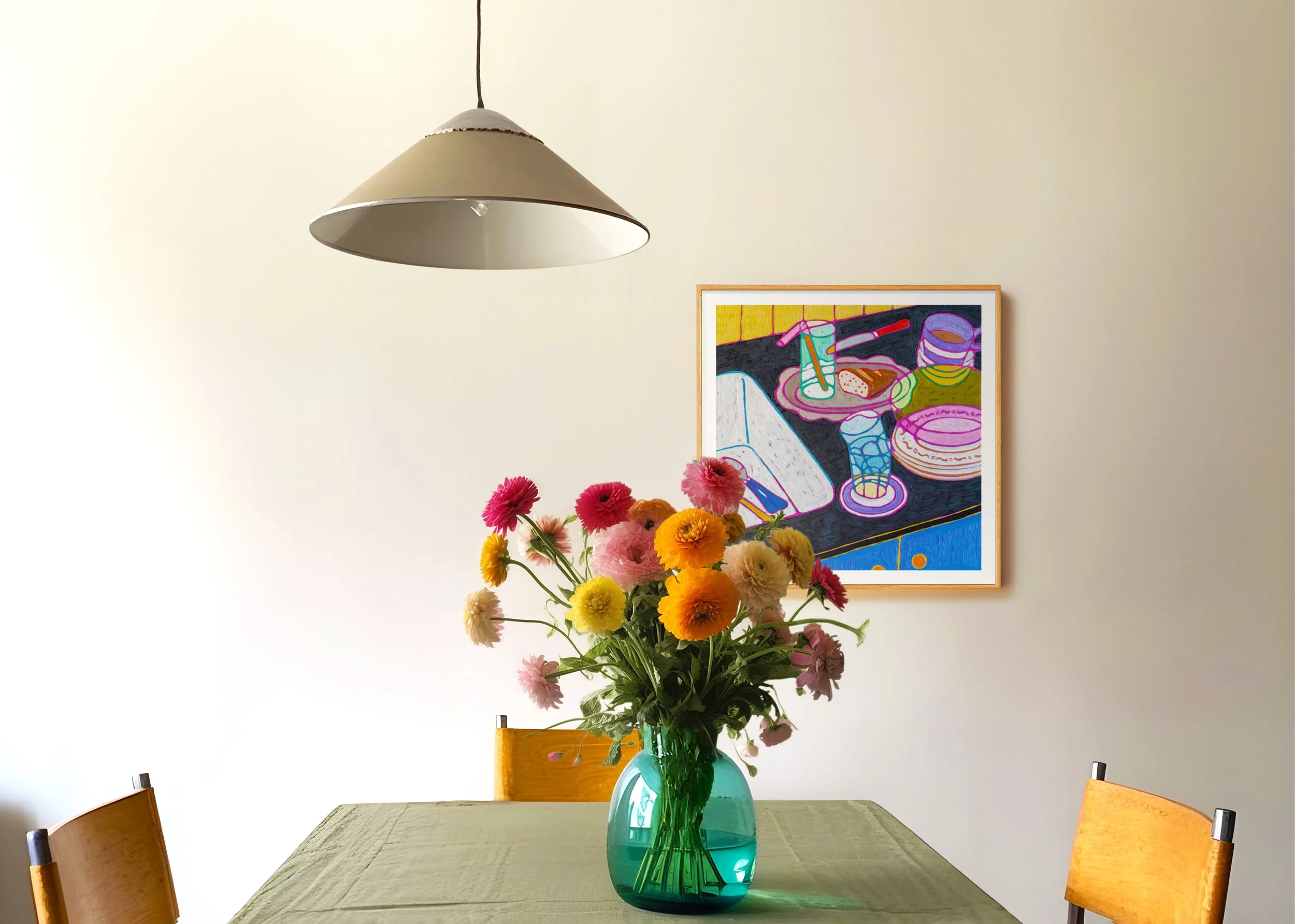 A dining room table with a green tablecloth, a vase of colorful flowers, a painting on the wall, and a hanging light.