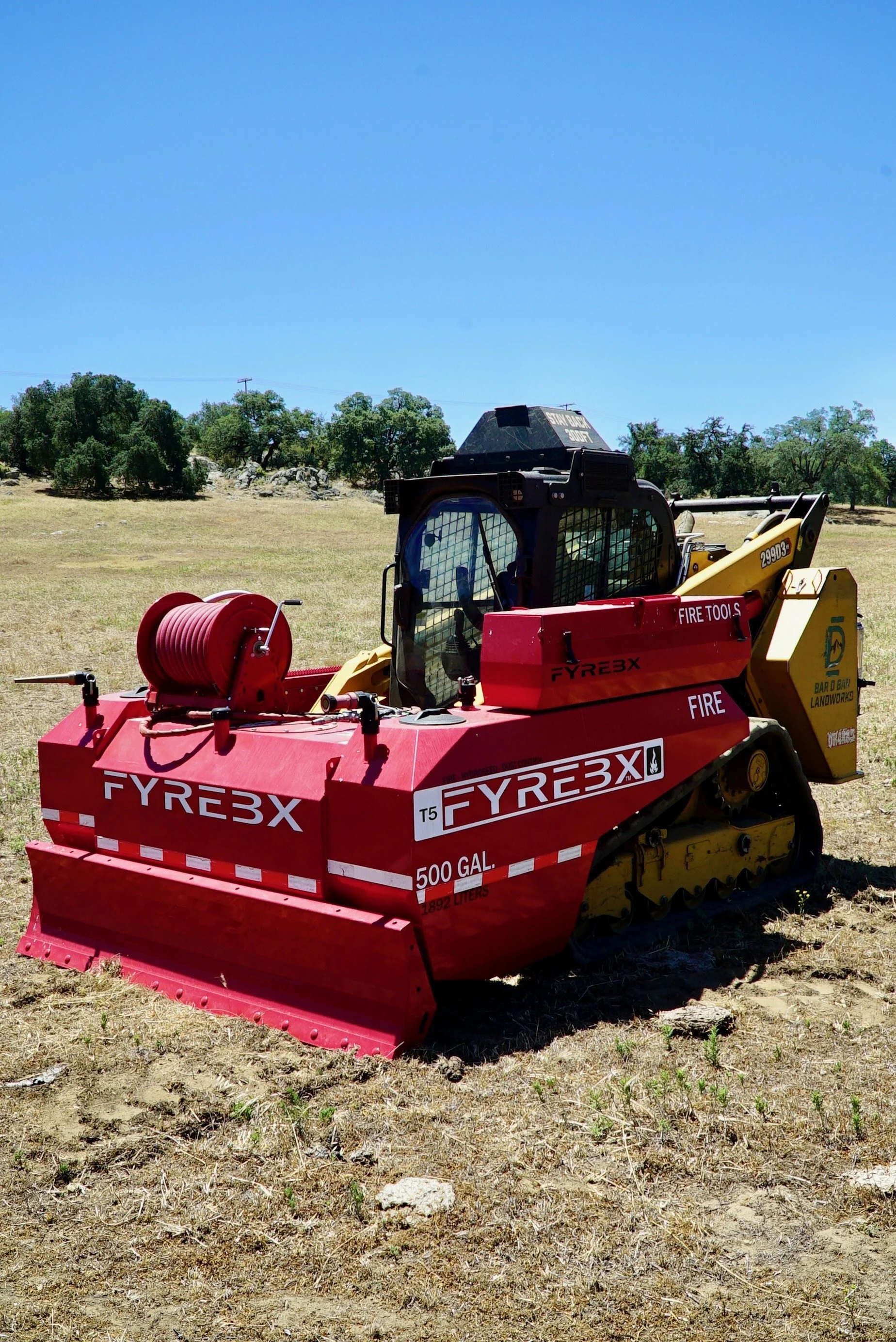 cat 299D3 skid steer with Fyrebx 5T attachment. 500 gallon fire suppression attachment for tracked skid steer