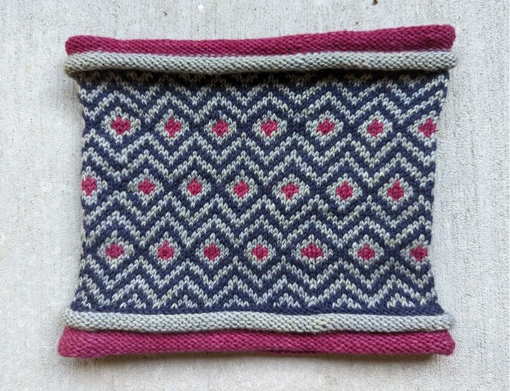 The Sunwick Cowl by the amazing Evelyn Bravata in Black Iris, Cranberry and light grey.