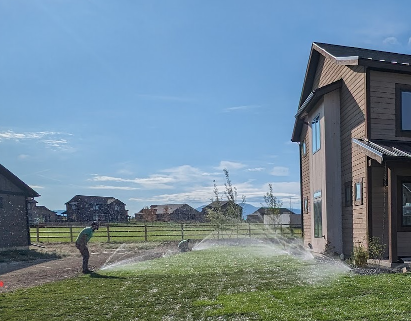 Sprinkler installers adjusting newly installed lawn sprinklers in Bozeman, MT