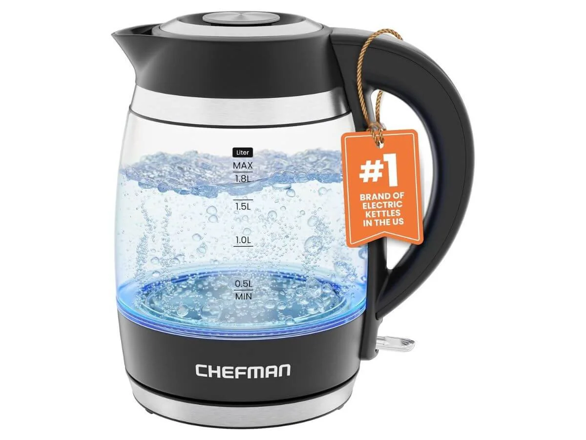 Glass electric kettle with boiling water and temperature markings.