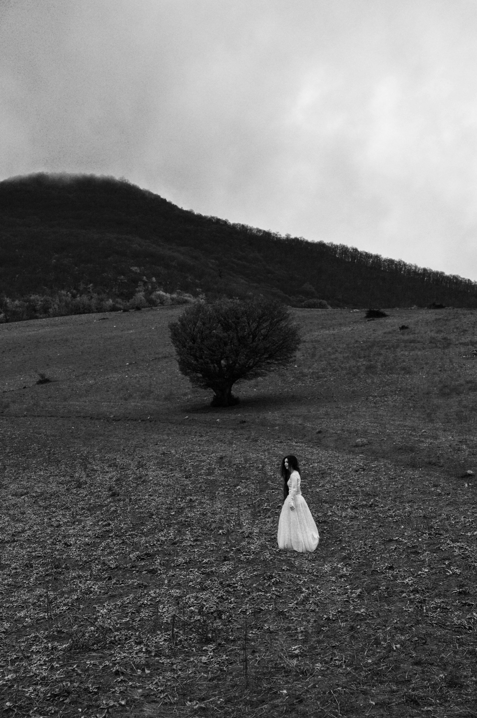 Woman in white roams countryside