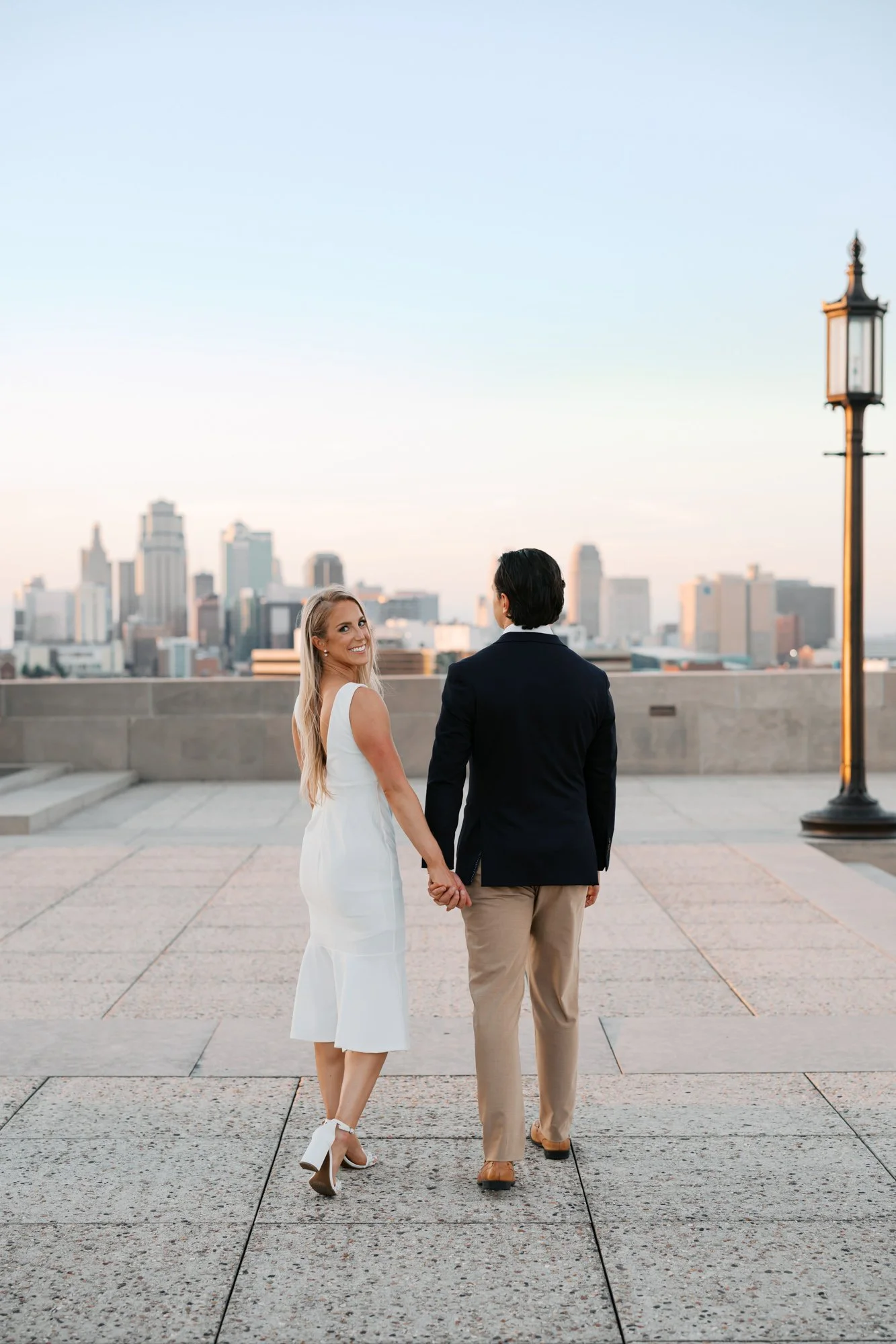 Couple walking at WW1 Museum and Kansas City skyline