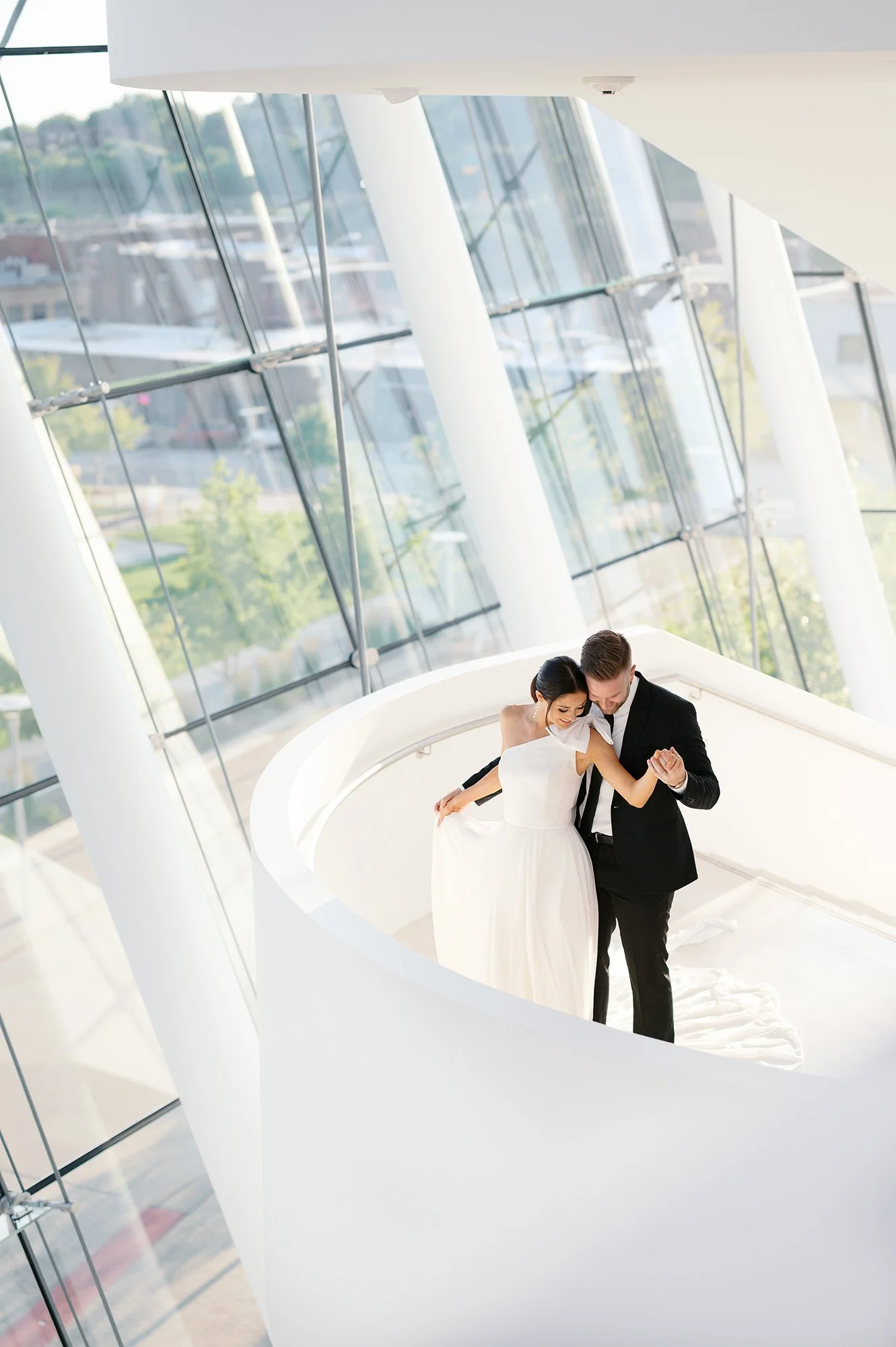 Kauffman Center for the Performing Arts Wedding Photos of a bride and groom on staircase. Modern, elegant and classy