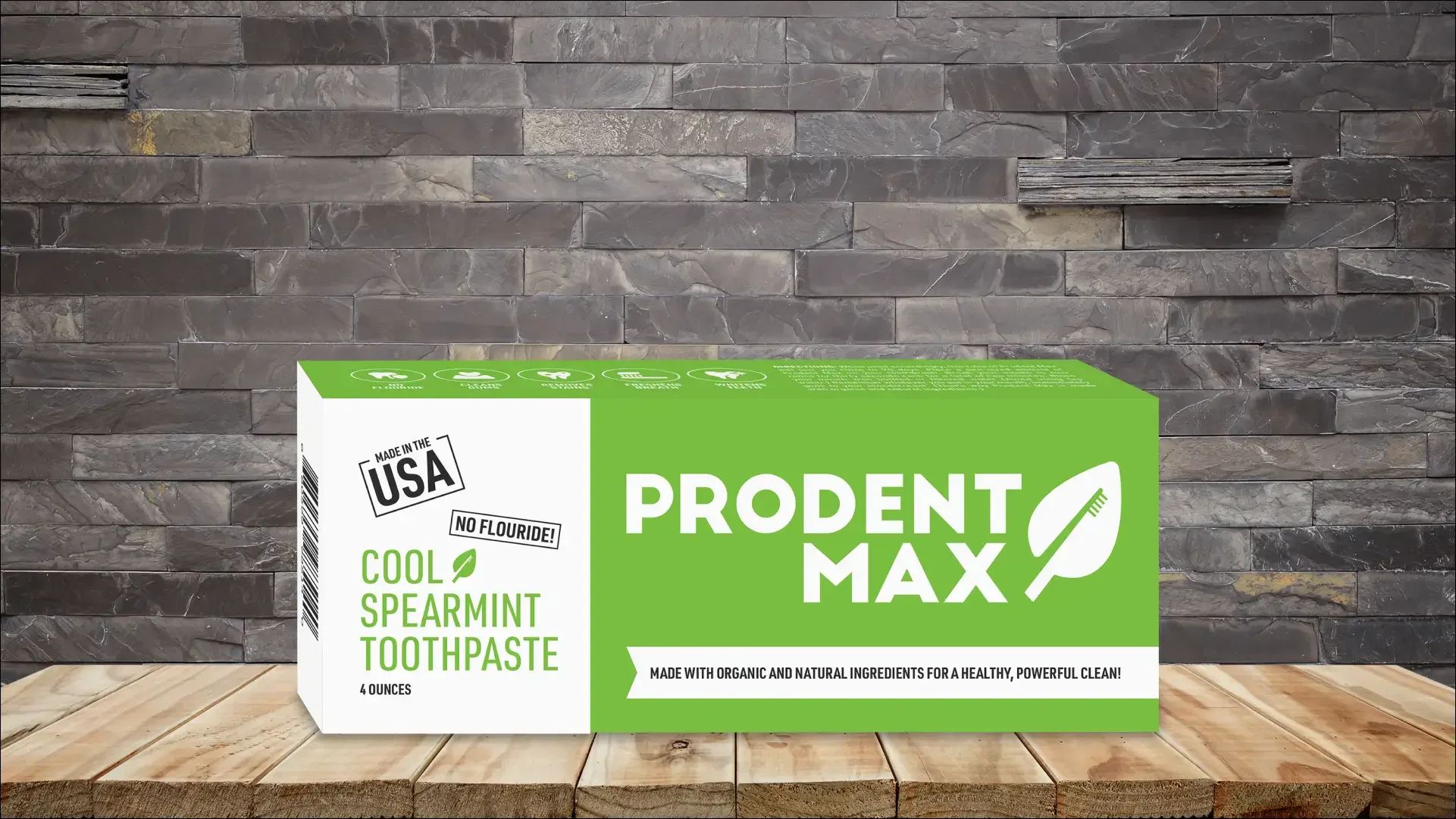 ProDent Max Cool Spearmint toothpaste box on wood against a stone wall.