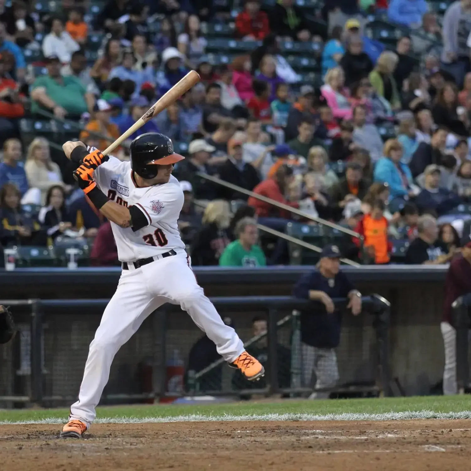 Baseball player swinging at a pitch during a game
