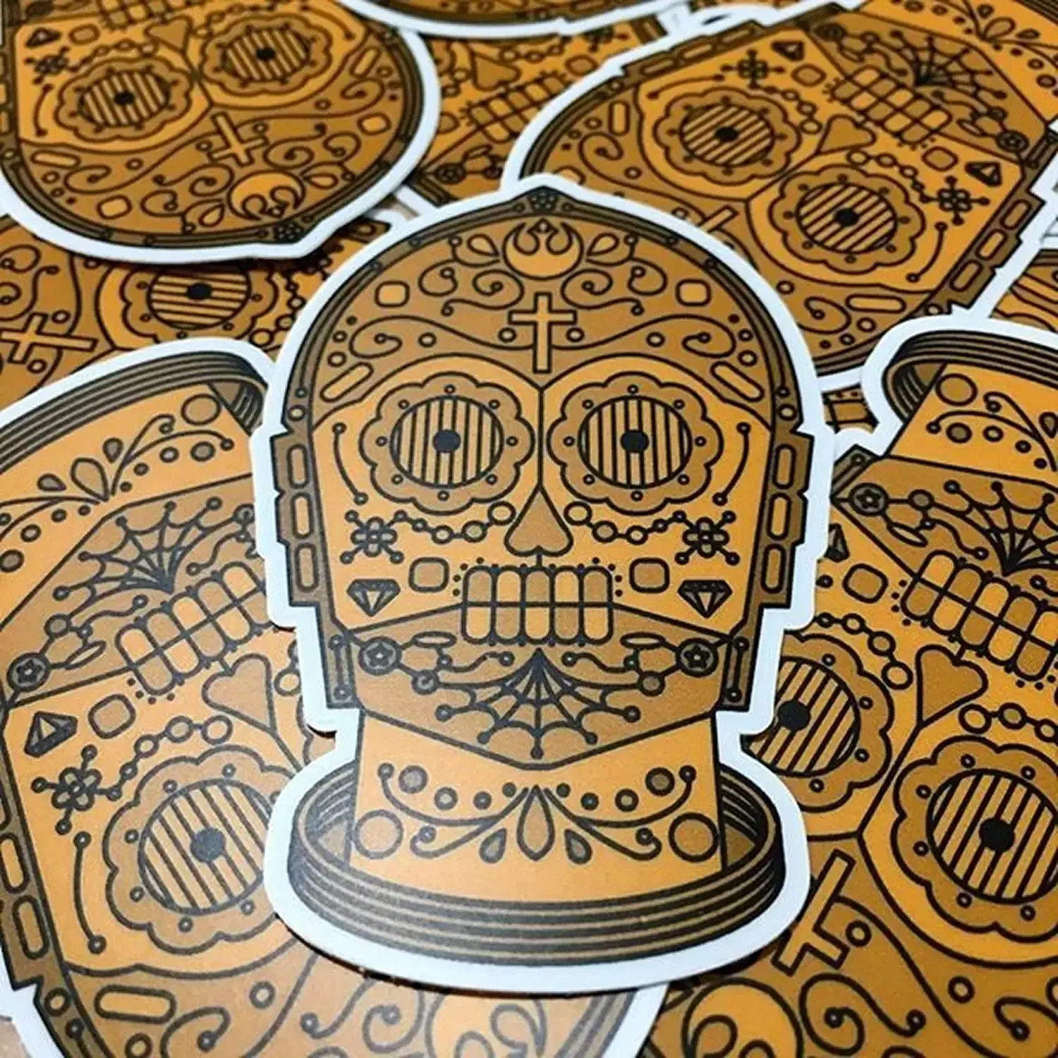 Illustrated sugar skull pattern in black and gold