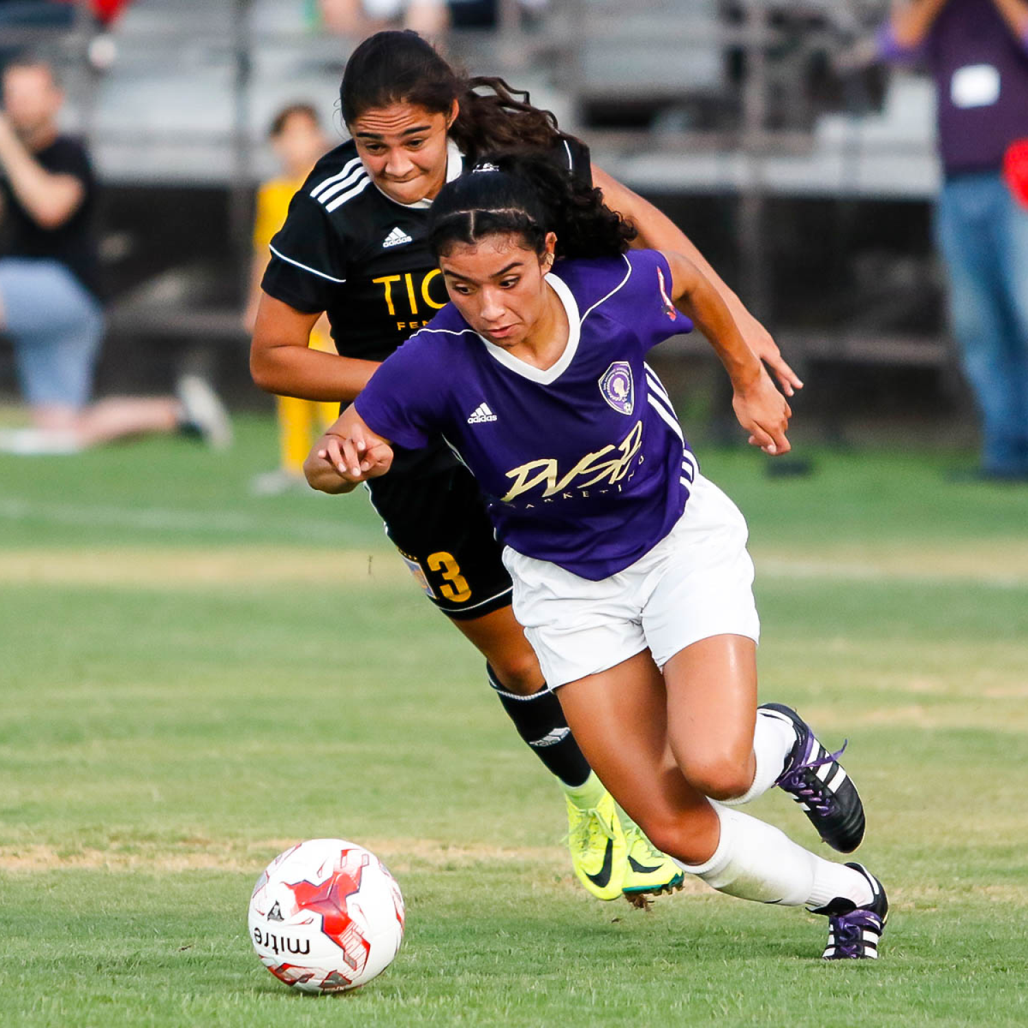 San Antonio Athenians player dribbling past a defender