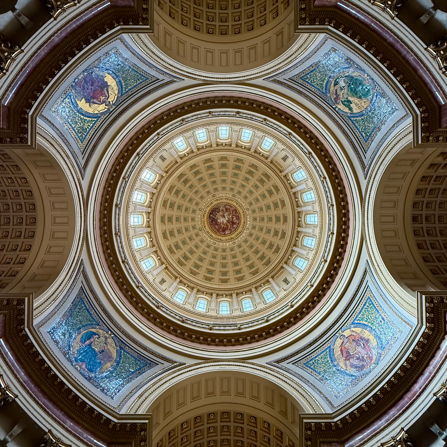 Ornate domed ceiling with murals and arched windows