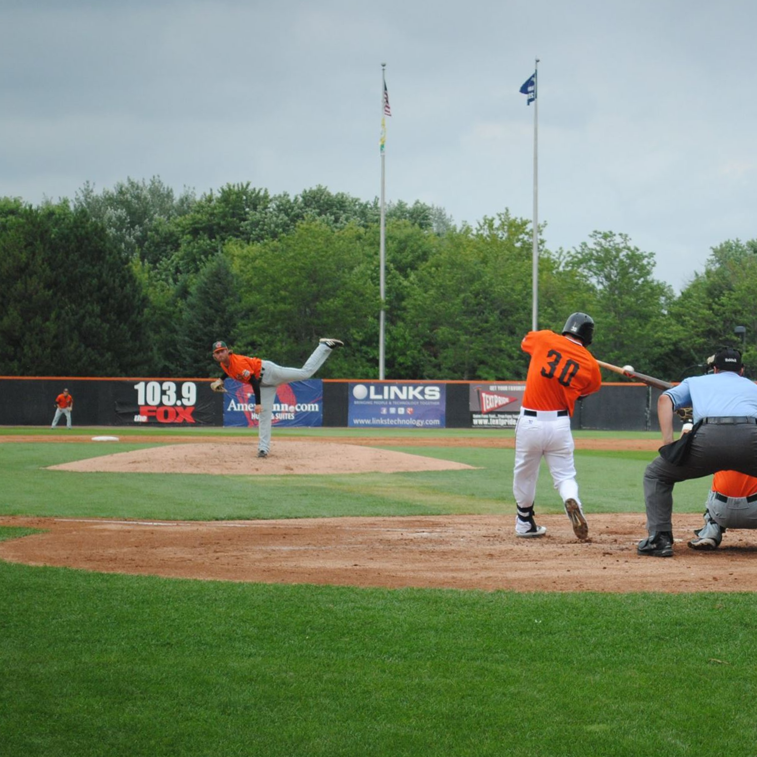 Baseball batter making contact at home plate
