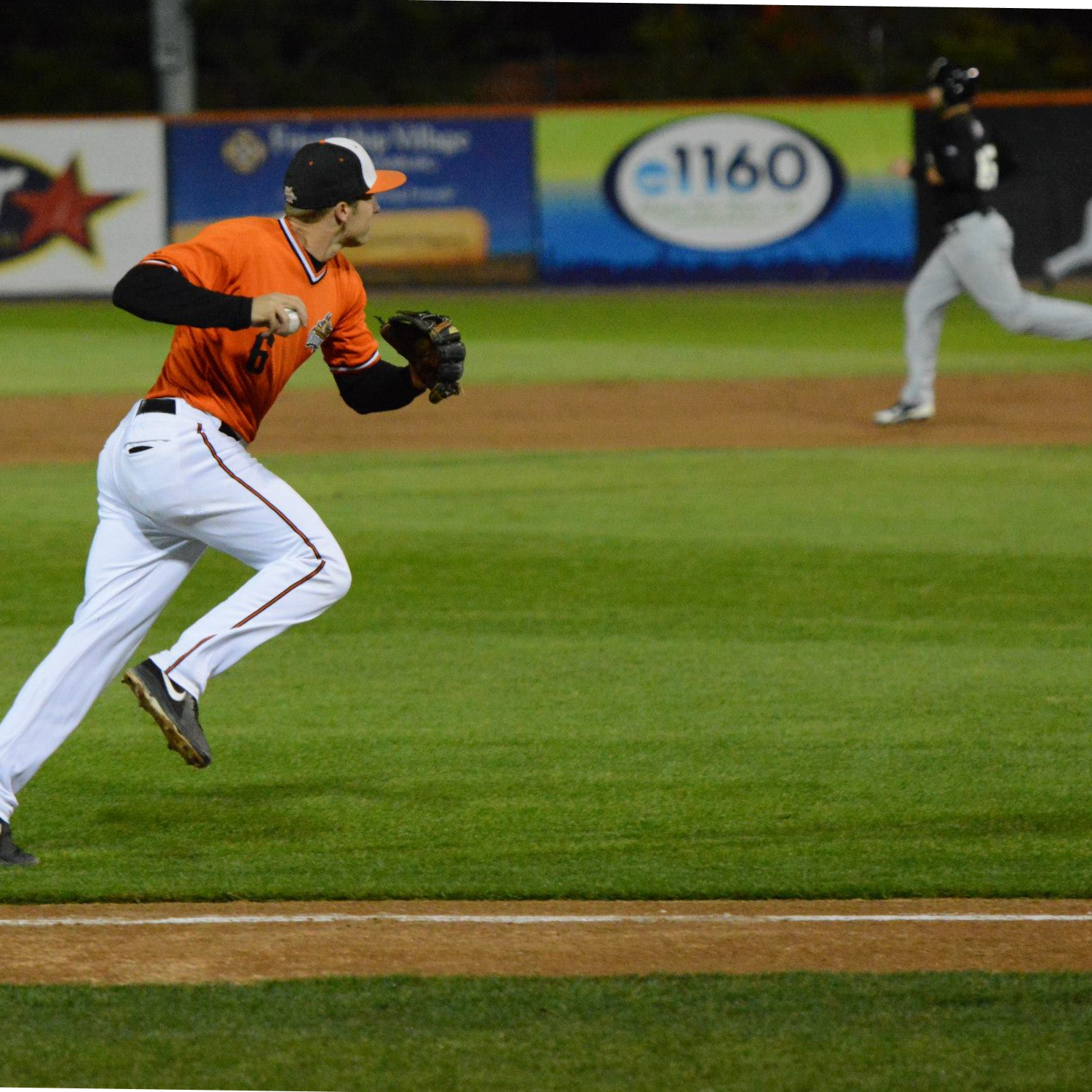 Baseball player running across the infield