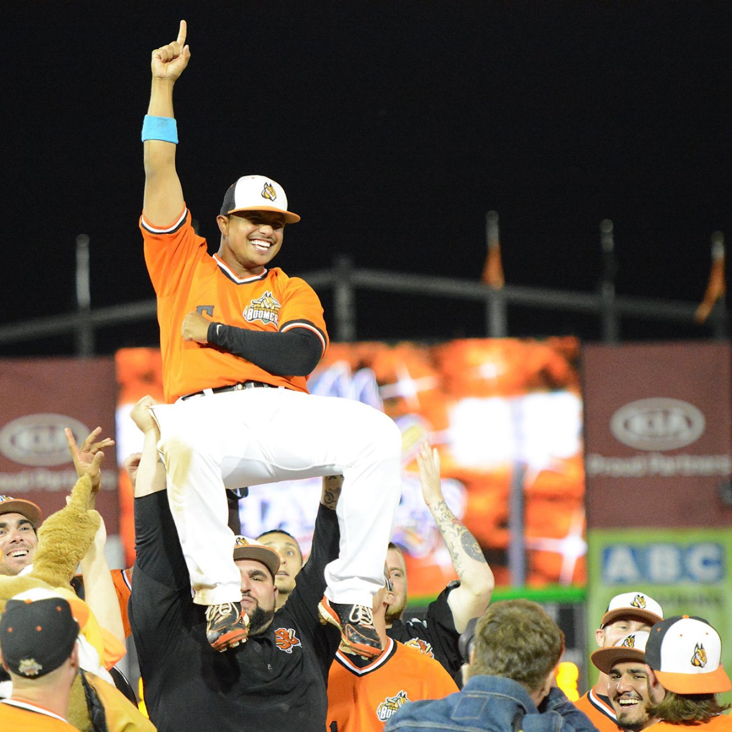 Baseball player celebrating on teammates shoulders