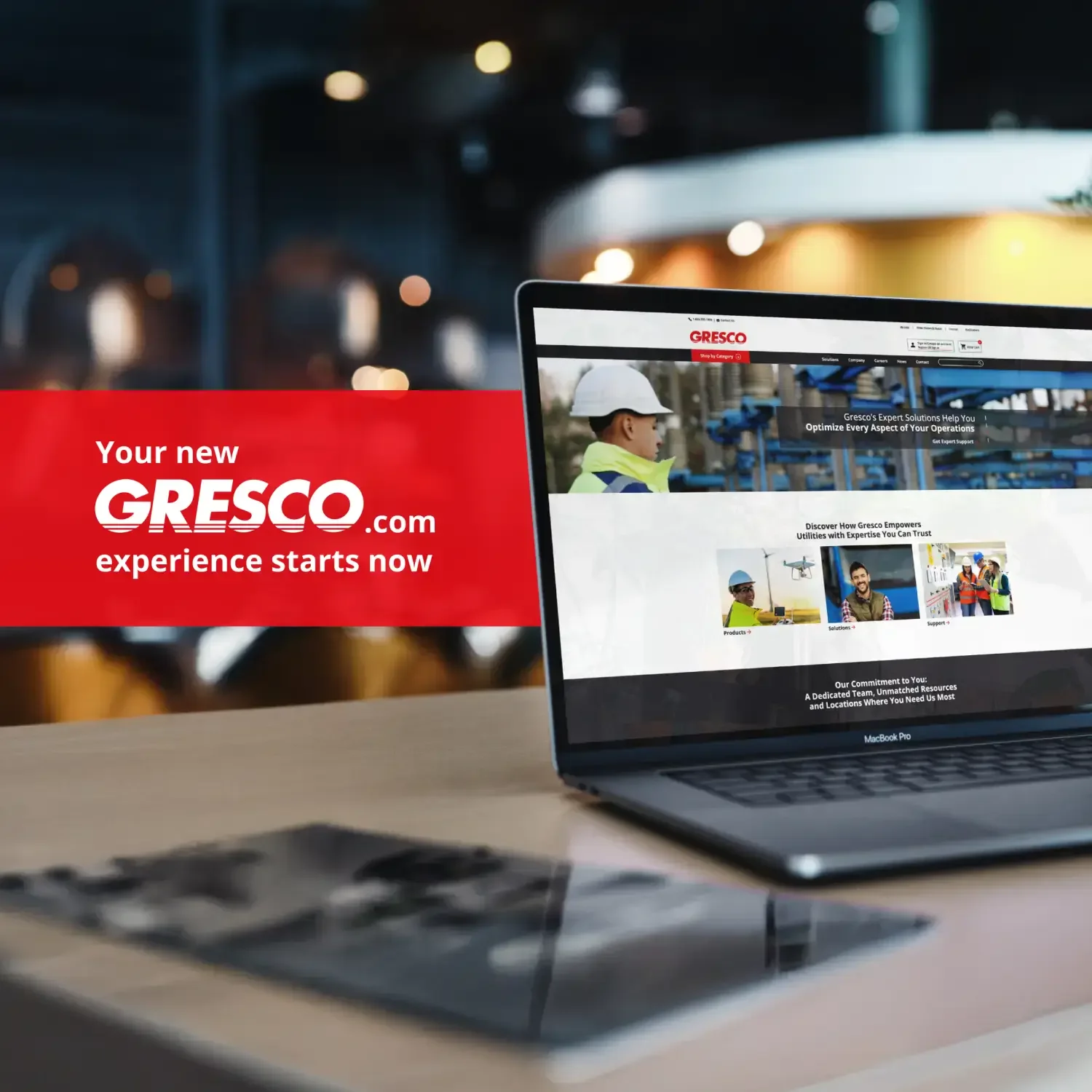 Gresco website launch displayed on a laptop beside a red announcement card