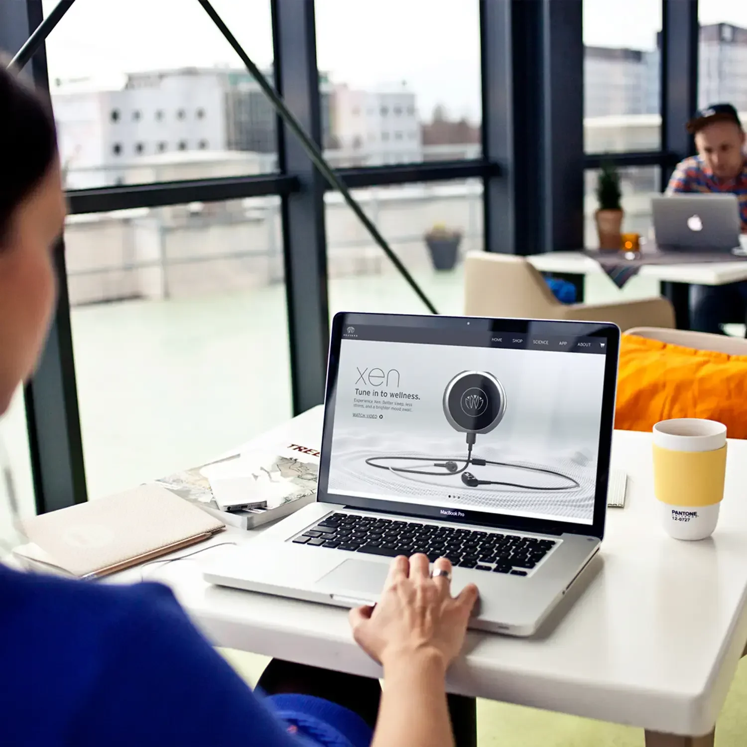Product landing page for a circular device displayed on an office laptop
