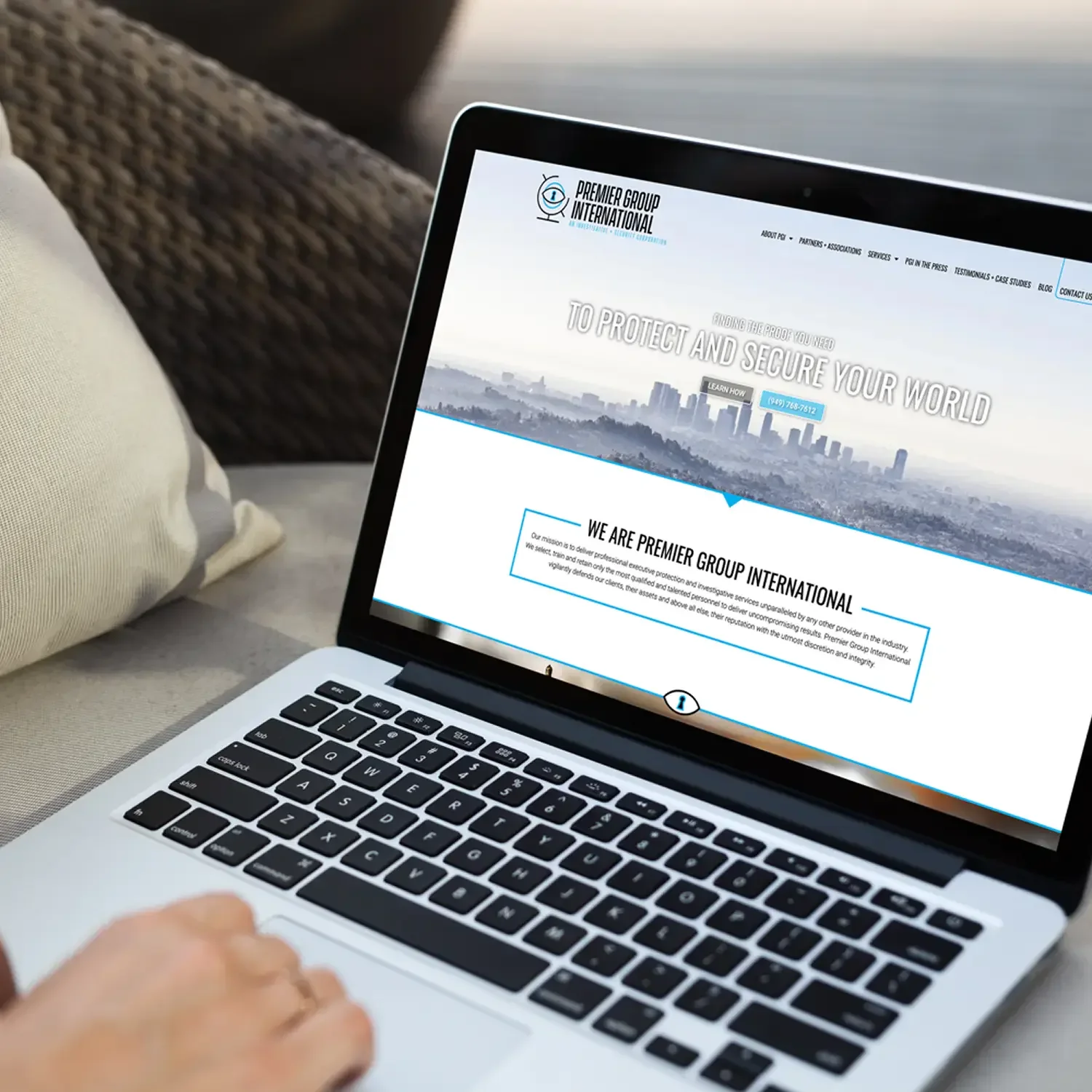 Construction company website displayed on a laptop with a city skyline header