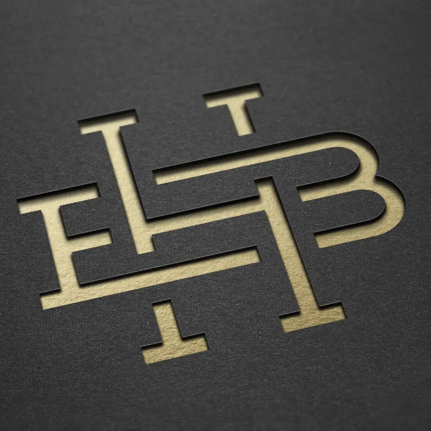 Gold monogram embossed on black paper
