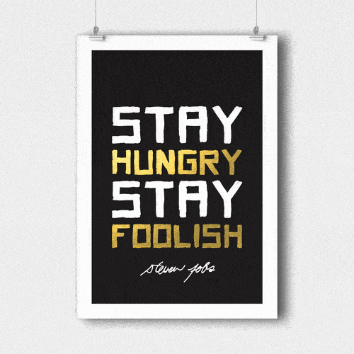 Chalkboard sign with the quote 'Stay hungry stay foolish' by Steve Jobs, with the words 'hungry' and 'foolish' highlighted in yellow.