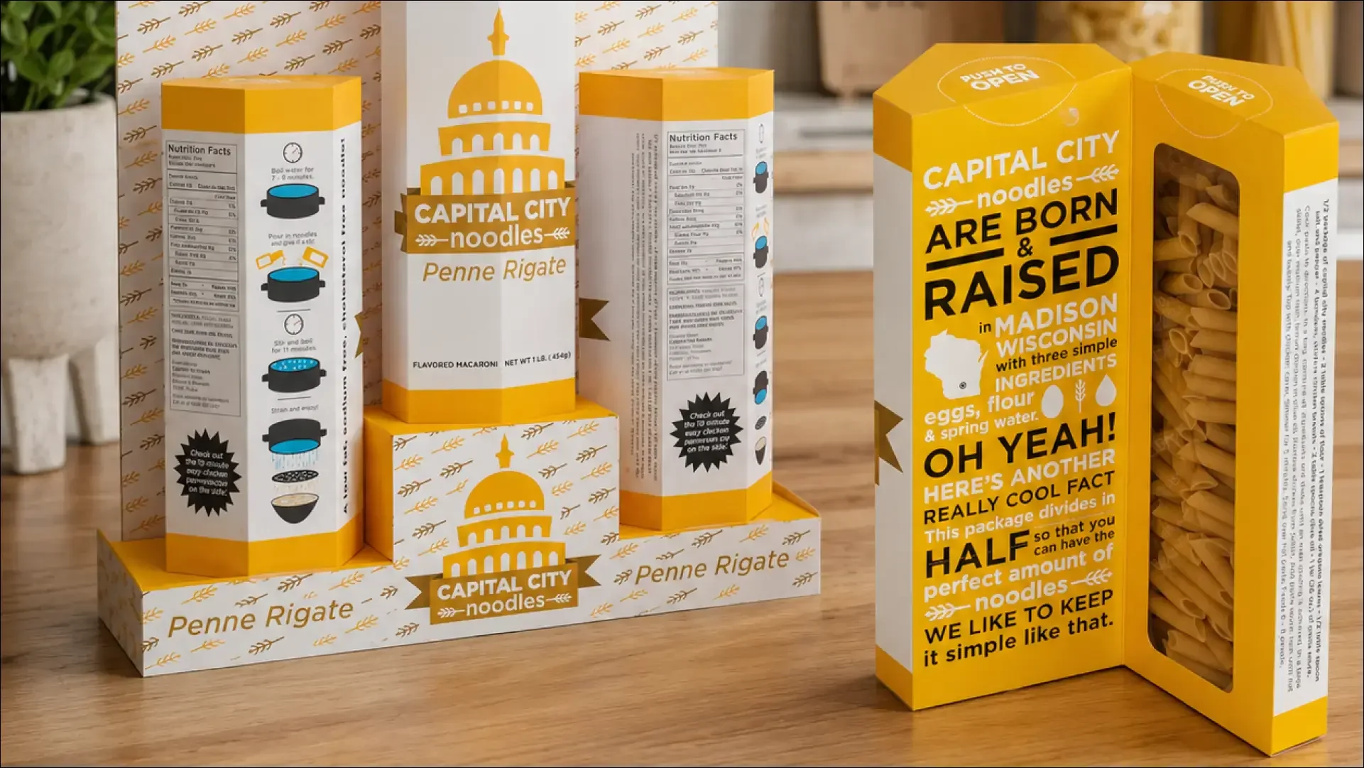 Capital City Pasta noodle packaging in yellow and white boxes.