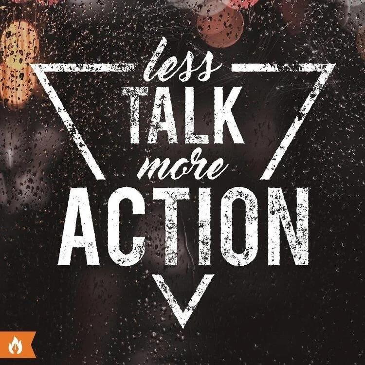 Hand-lettered quote 'Less talk more action' in white text on a black chalkboard background with decorative flourishes.