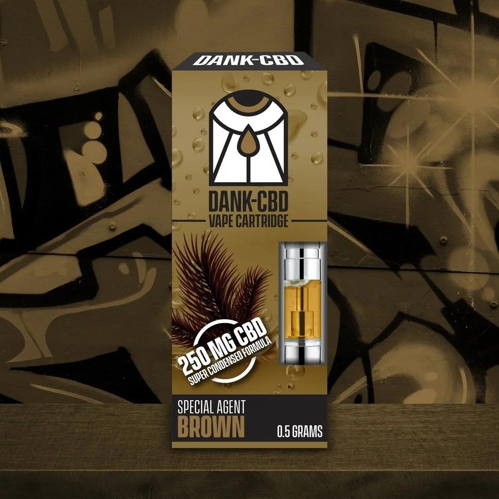 Packaging for Dank-CBD vape cartridge with a gold and brown color scheme, featuring a logo with a stylized figure and text indicating 250 mg CBD, super condensed formula, and a brown special agent flavor, 0.5 grams.