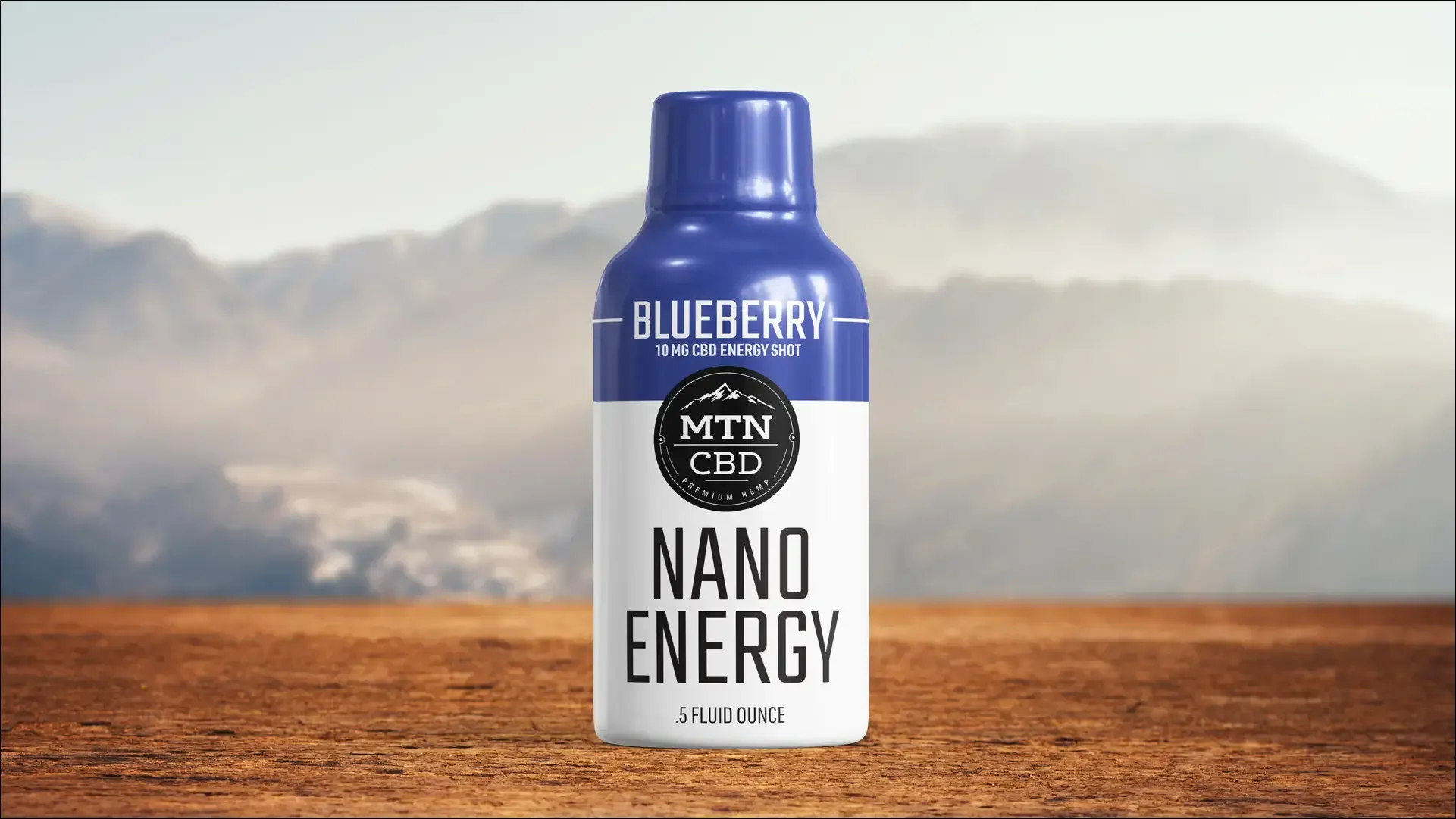 Blueberry CBD Nano Energy Shot can against a mountain landscape.