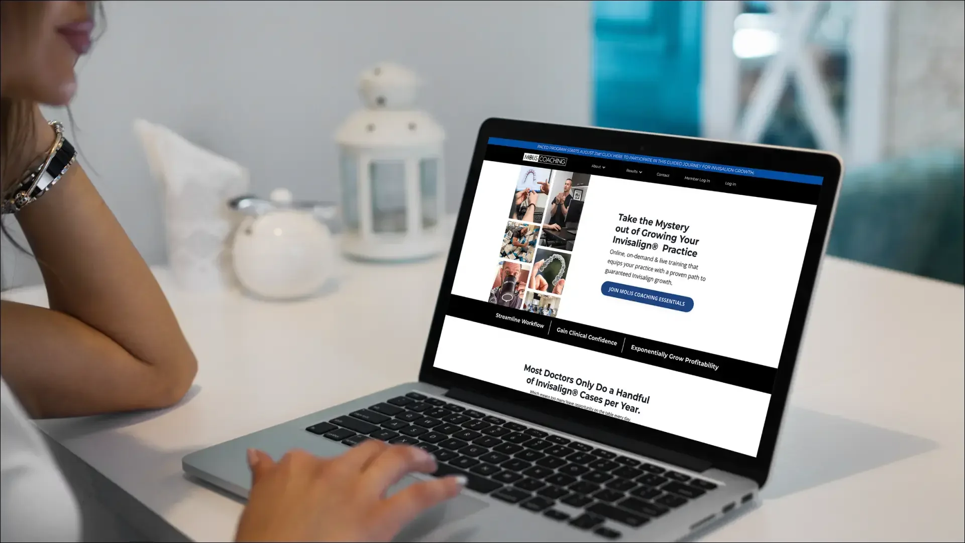 Invisalign coaching website displayed on a silver laptop.