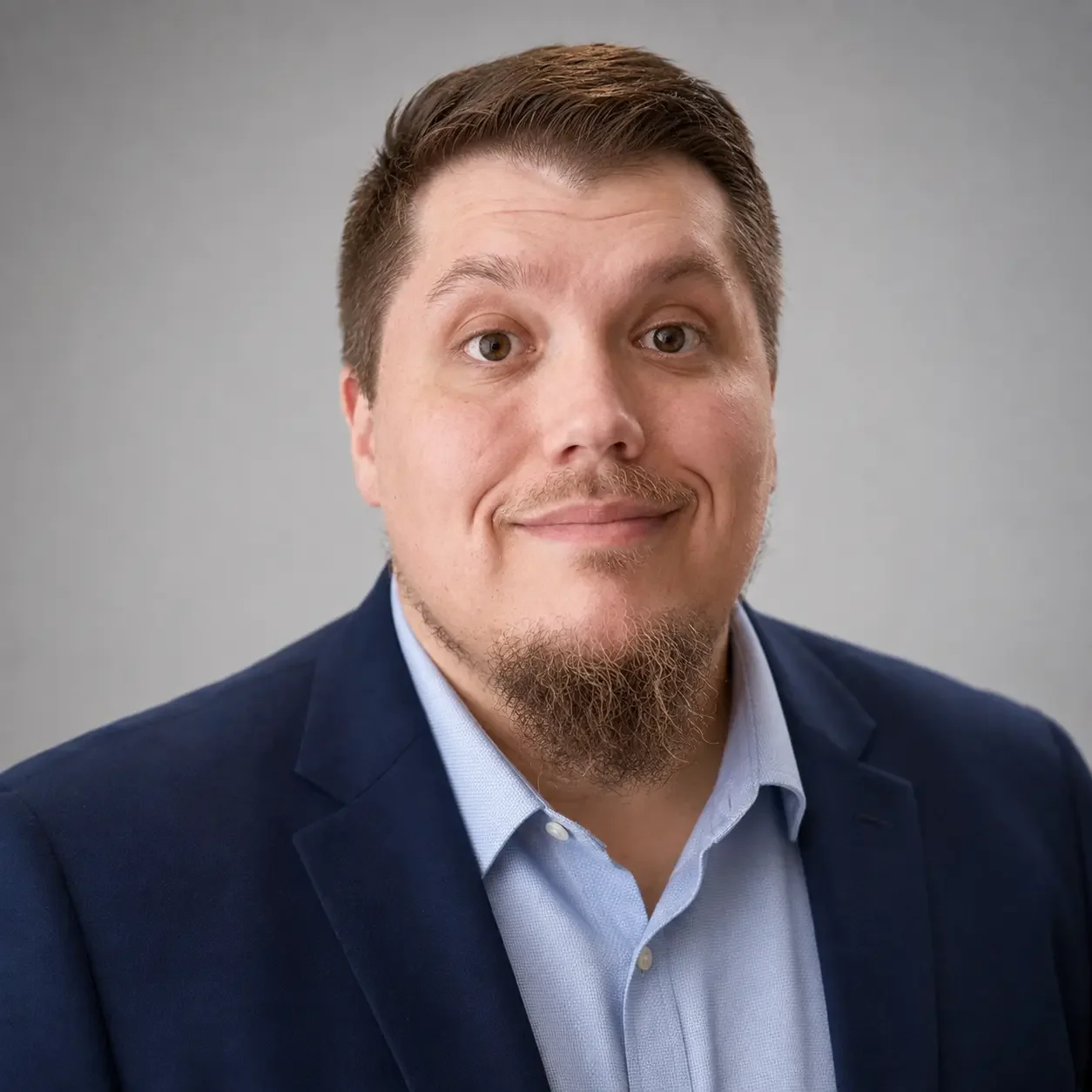Parker Lee smiling in a navy suit