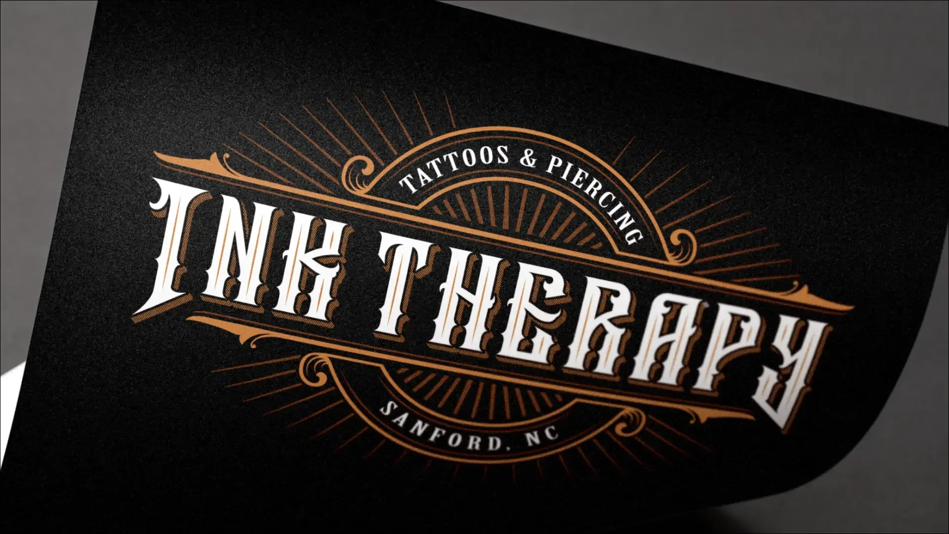 Ink Therapy Tattoos & Piercing logo on a black background.