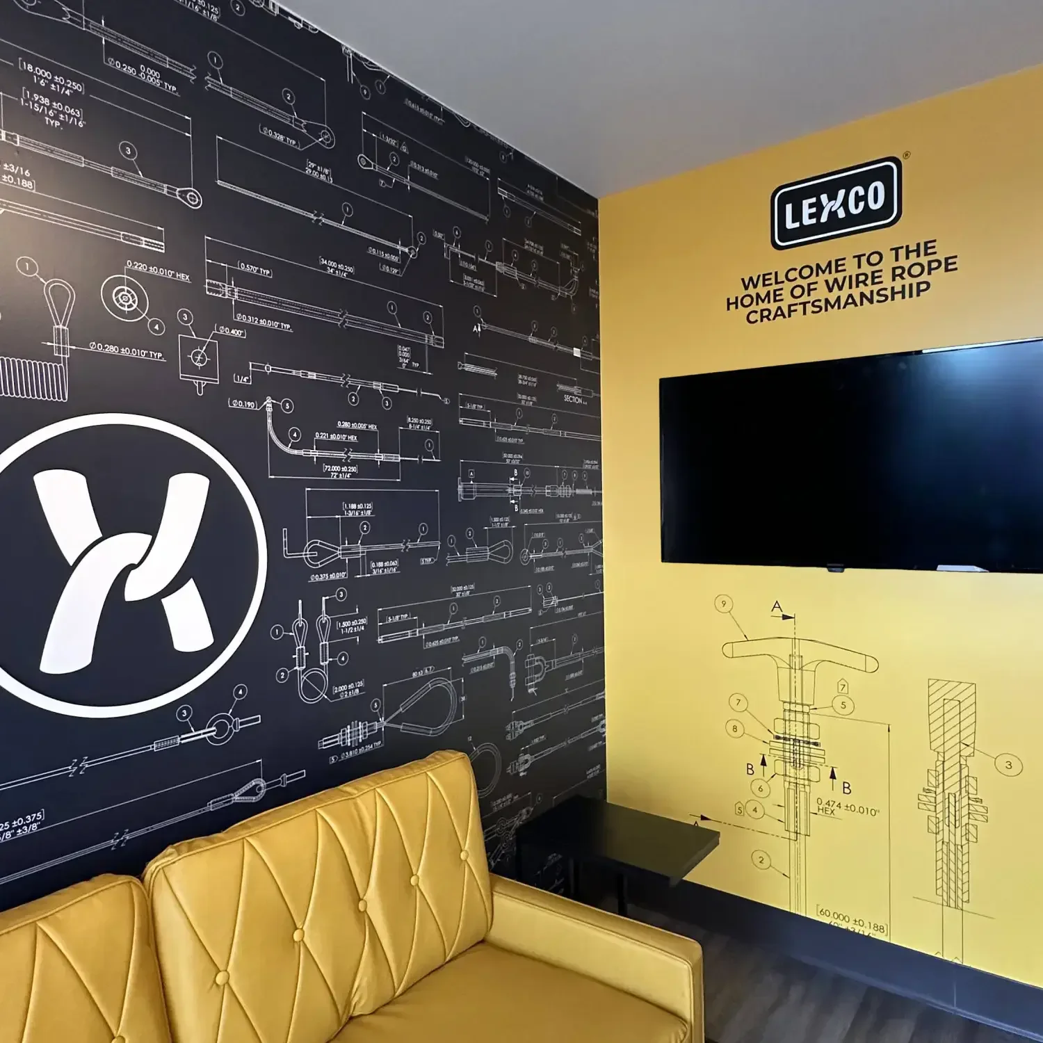 LEXCO lobby with wire-rope technical drawings, signage, and a yellow bench.