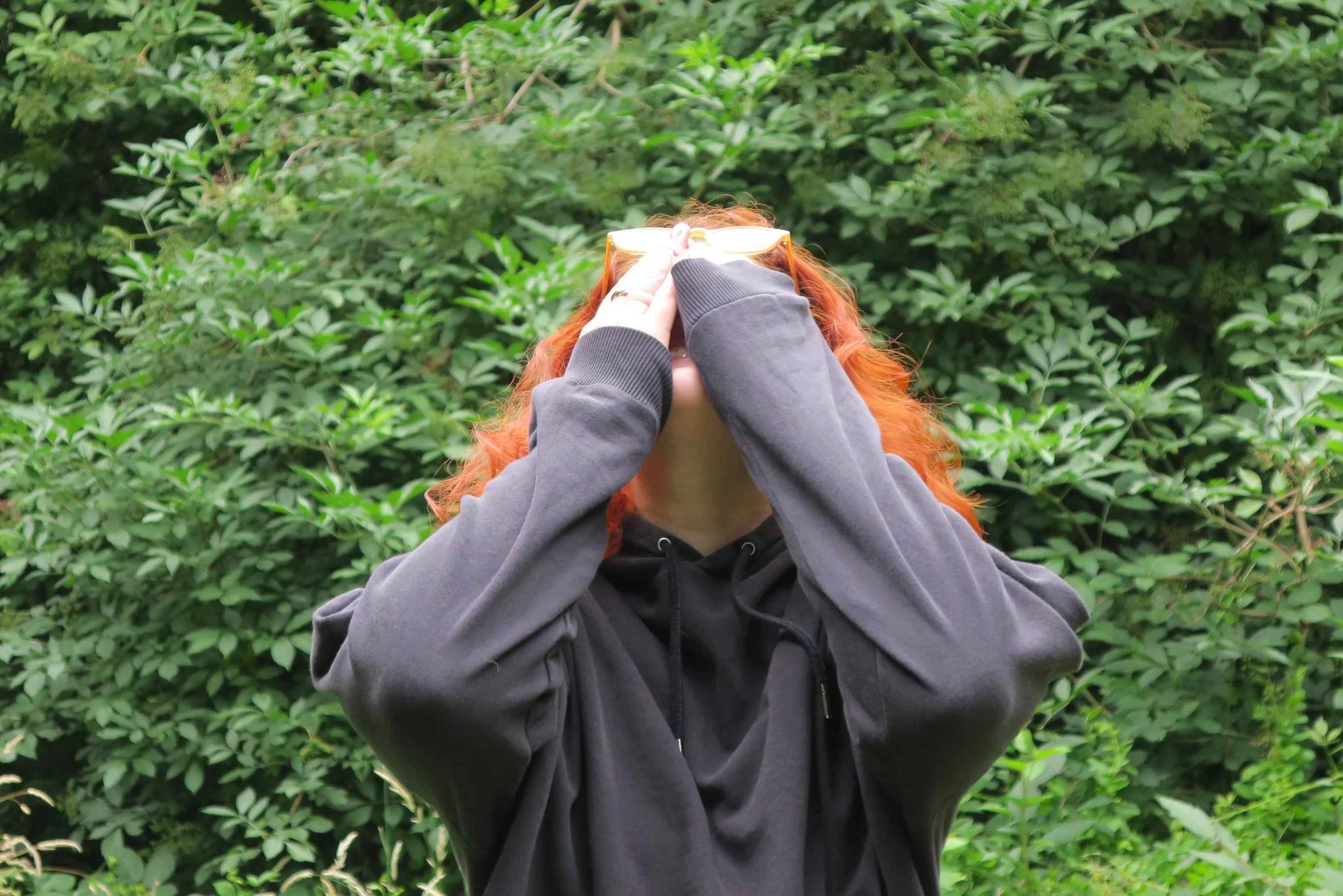 Susannah, head thrown back, hiding her face with her hands