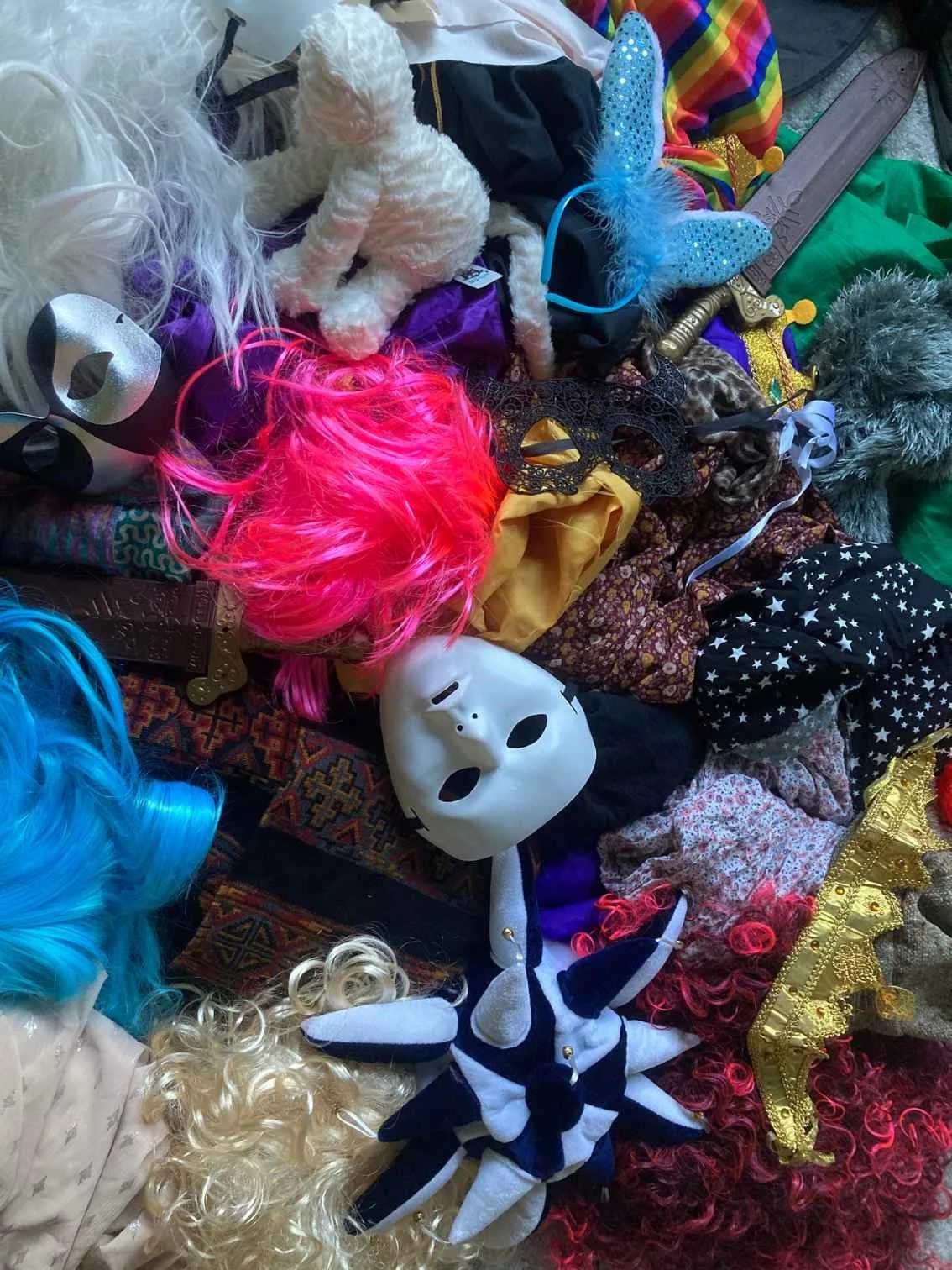Pile of colourful props, costumes, wigs and masks