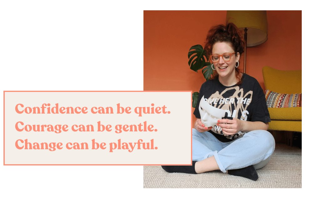 Susannah sits cross-legged on a living room floor, holding a drama mask and laughing mid-conversation, capturing a playful dramatherapy moment. Text overlay: “Confidence can be quiet, courage can be gentle, change can be playful.”