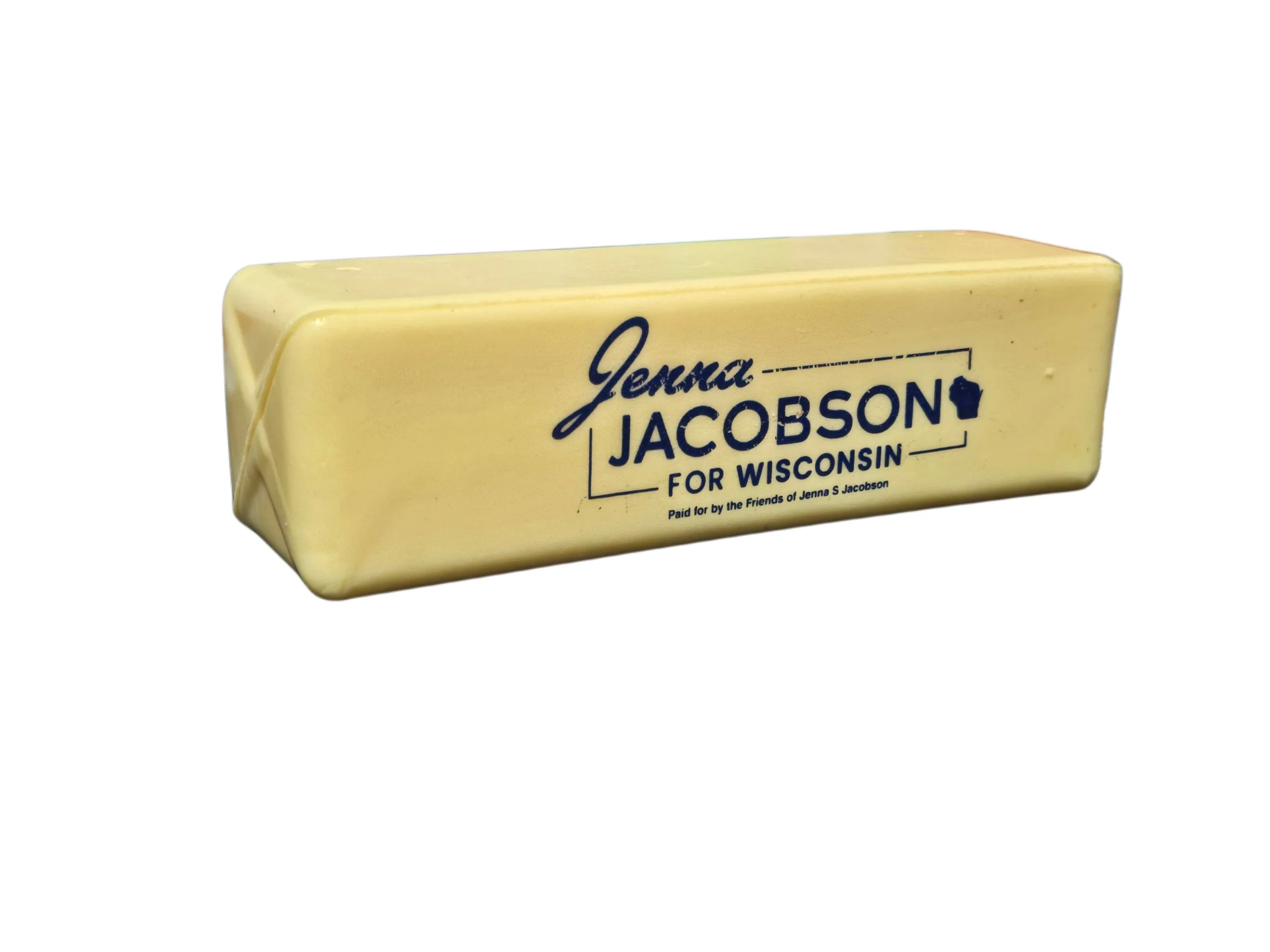 Yellow squishy in the shape of a stick of butter with the Jenna Jacobson for Wisconsin logo on it