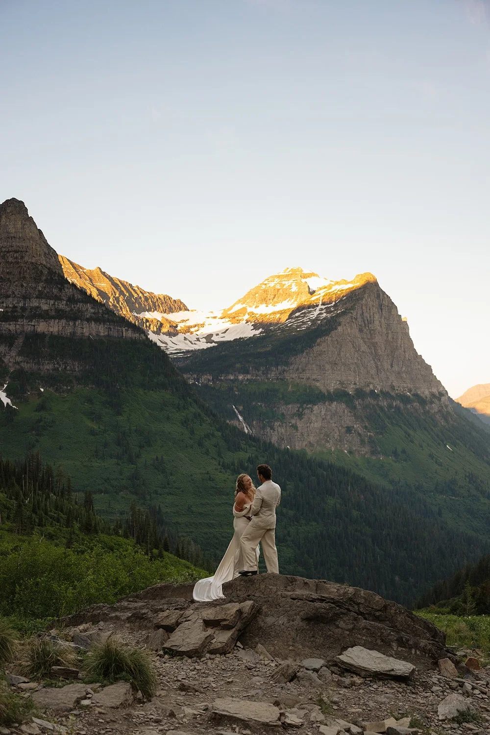 couple kisses on rock at mountaintop elopement