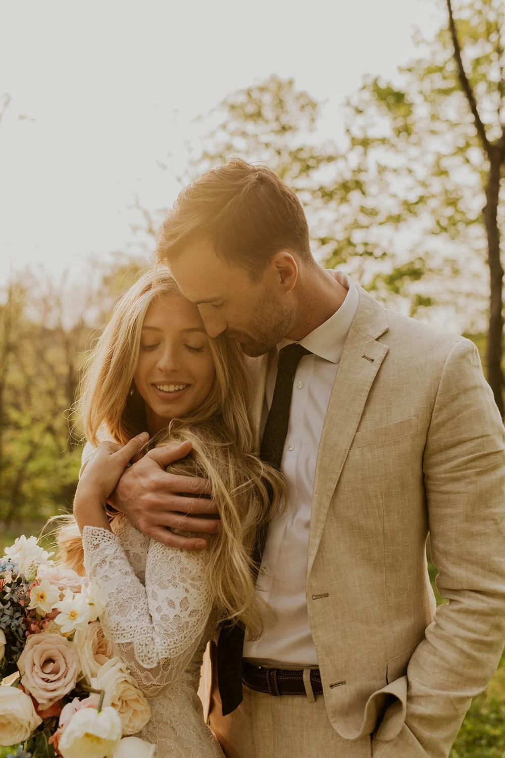 couple embraces at sunset elopement