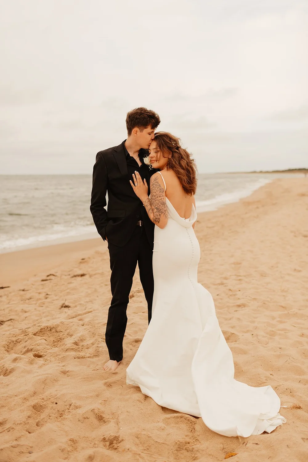 couple embraces at beach elopement