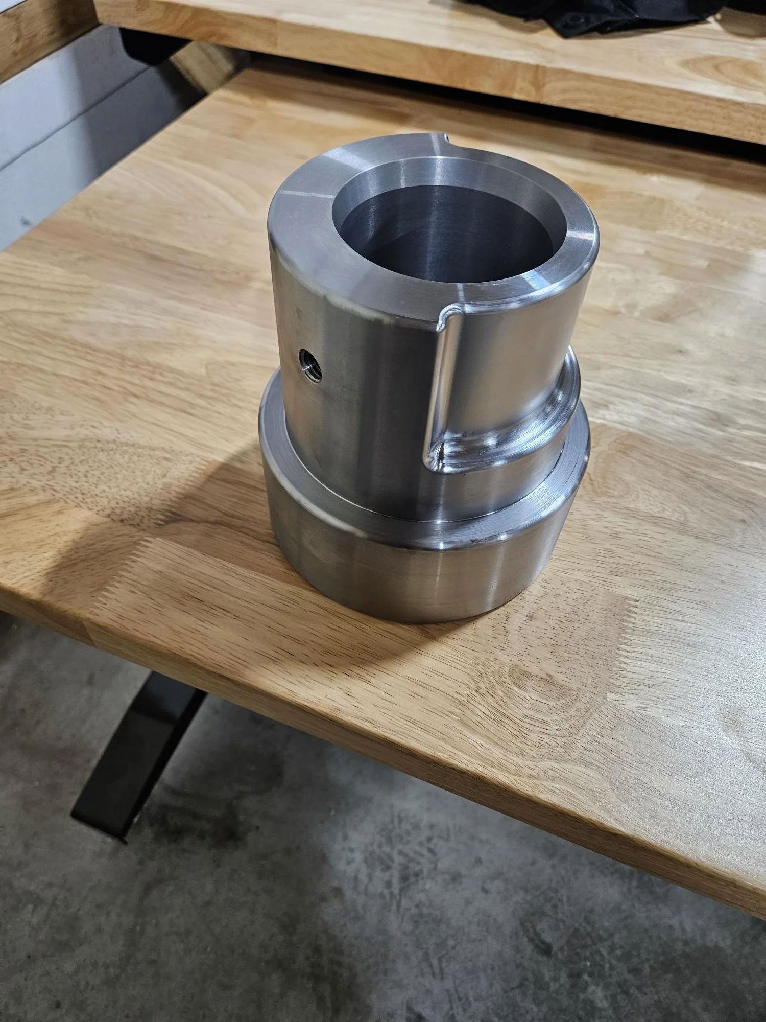 Metal cylindrical component on a wooden table