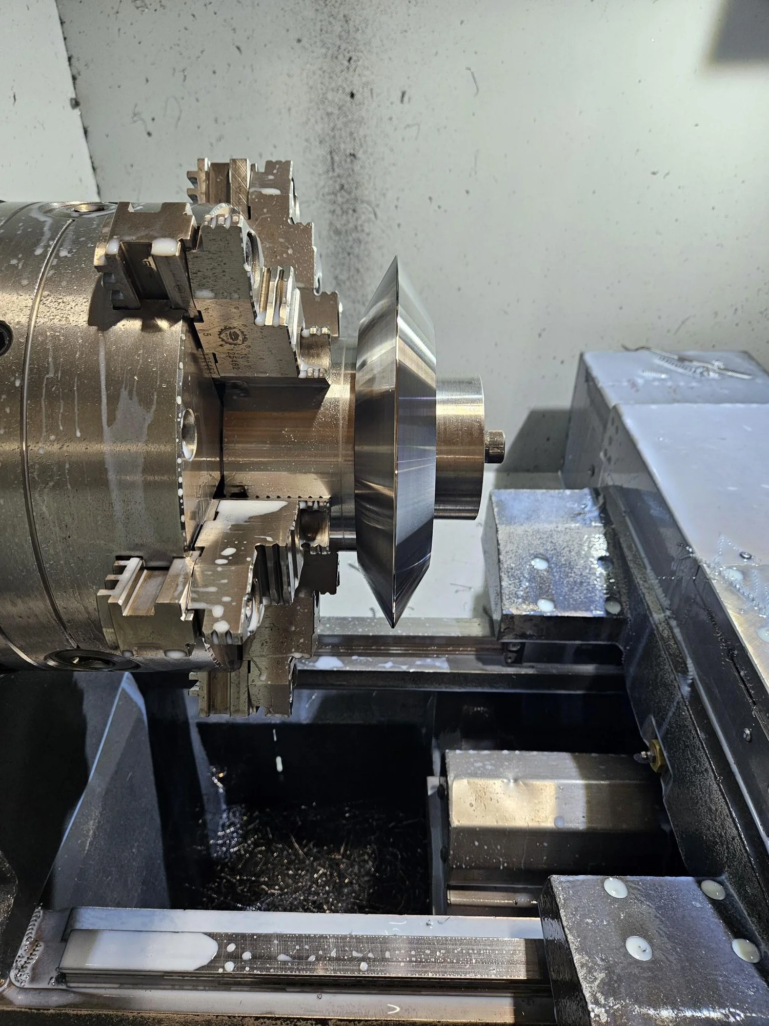 CNC lathe machine with metal workpiece being machined