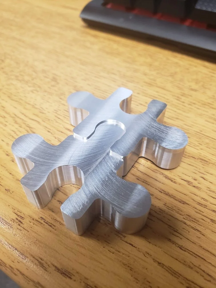 Metal puzzle piece on wooden surface