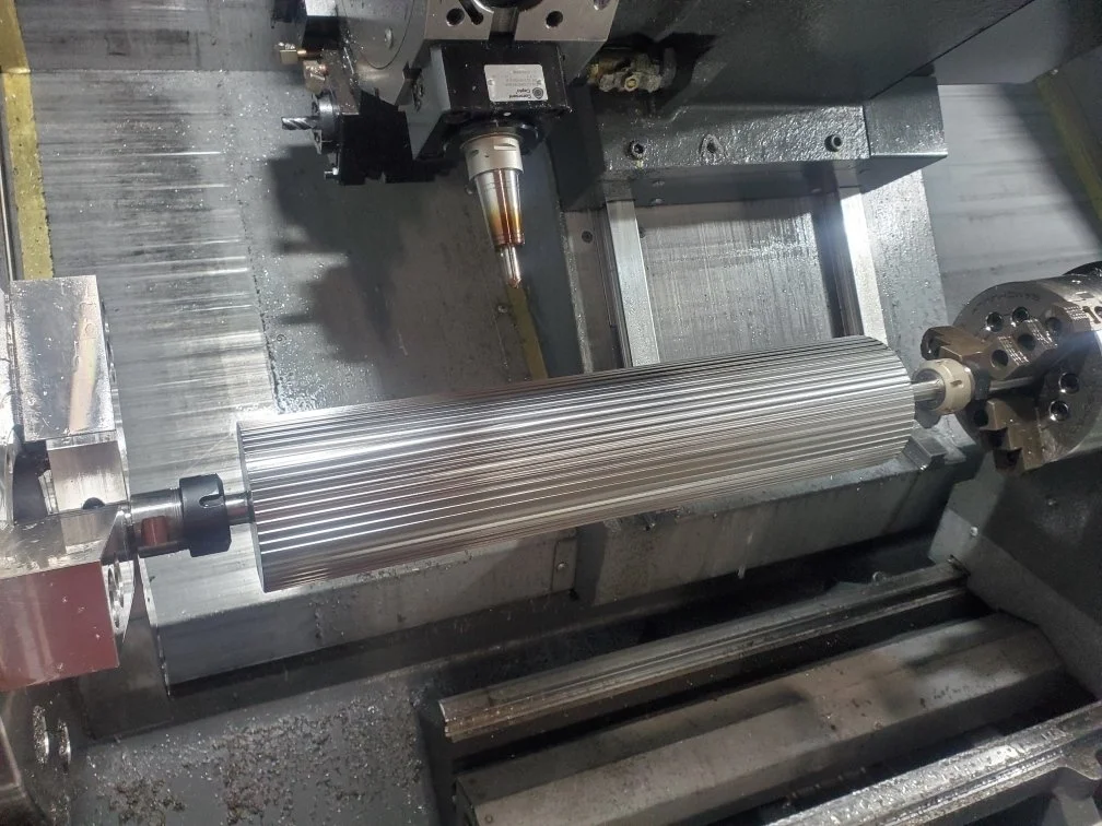 CNC machine with a cylindrical metal workpiece