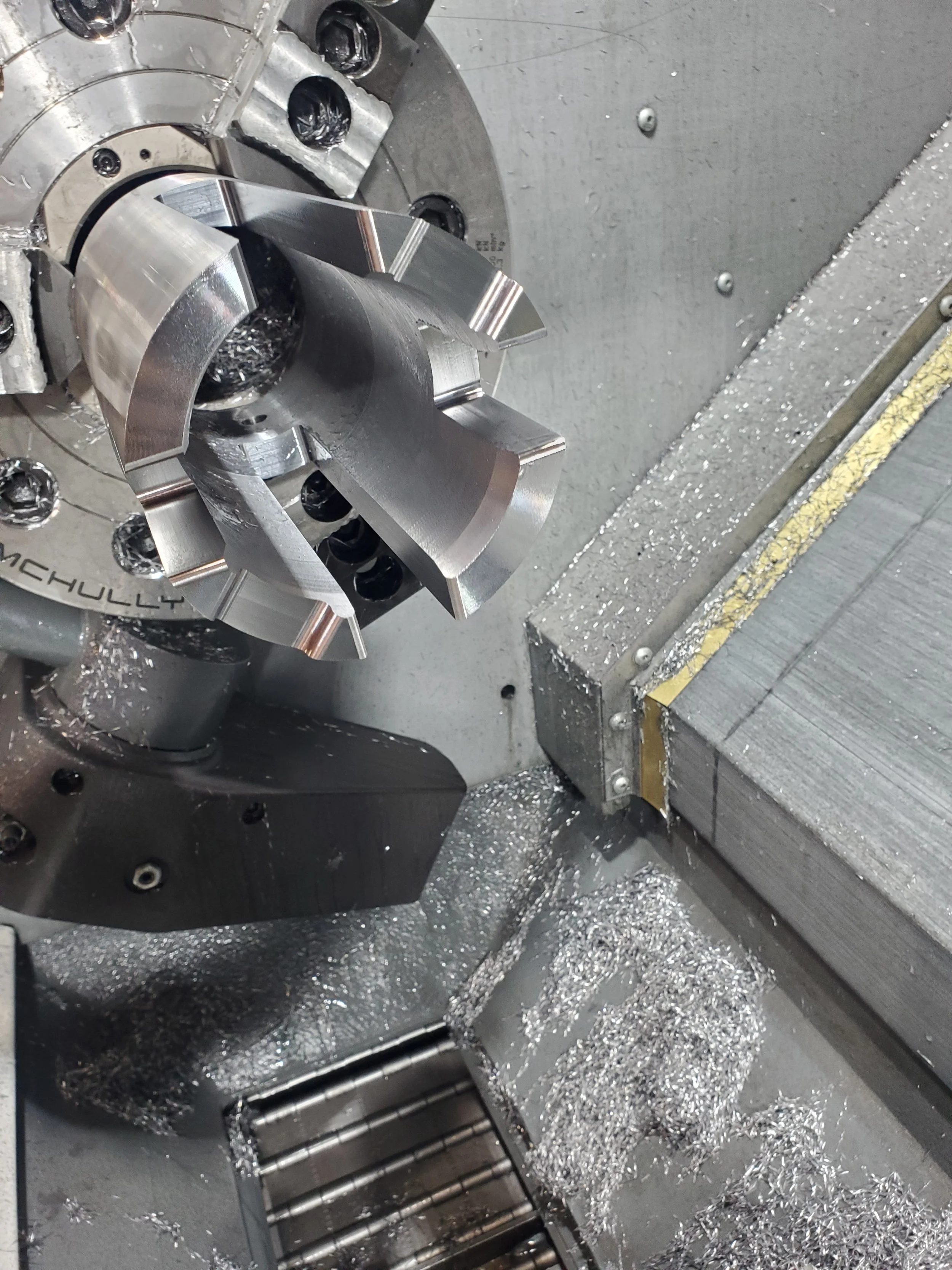 CNC lathe machine with metal workpiece and shavings