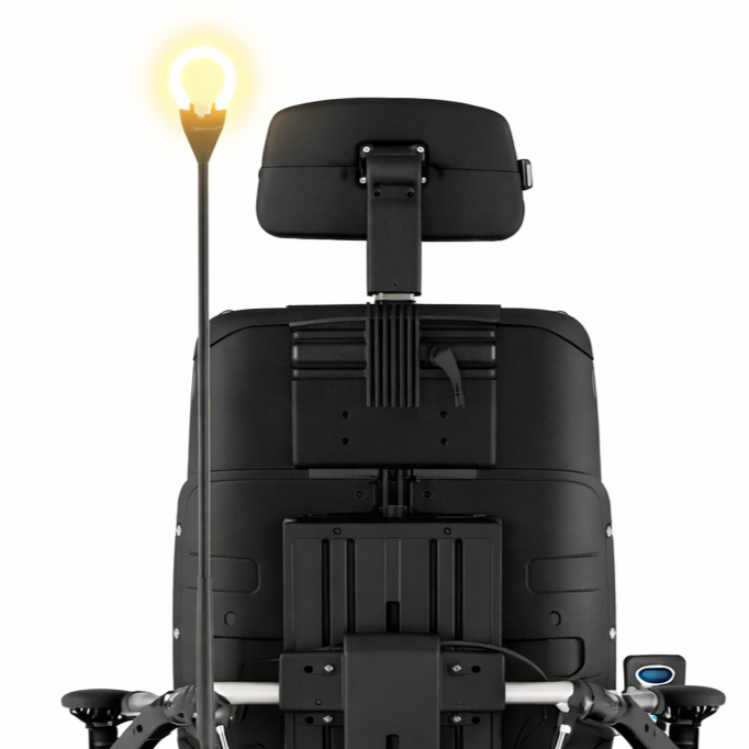 Rear view of a wheelchair with an attachable light.