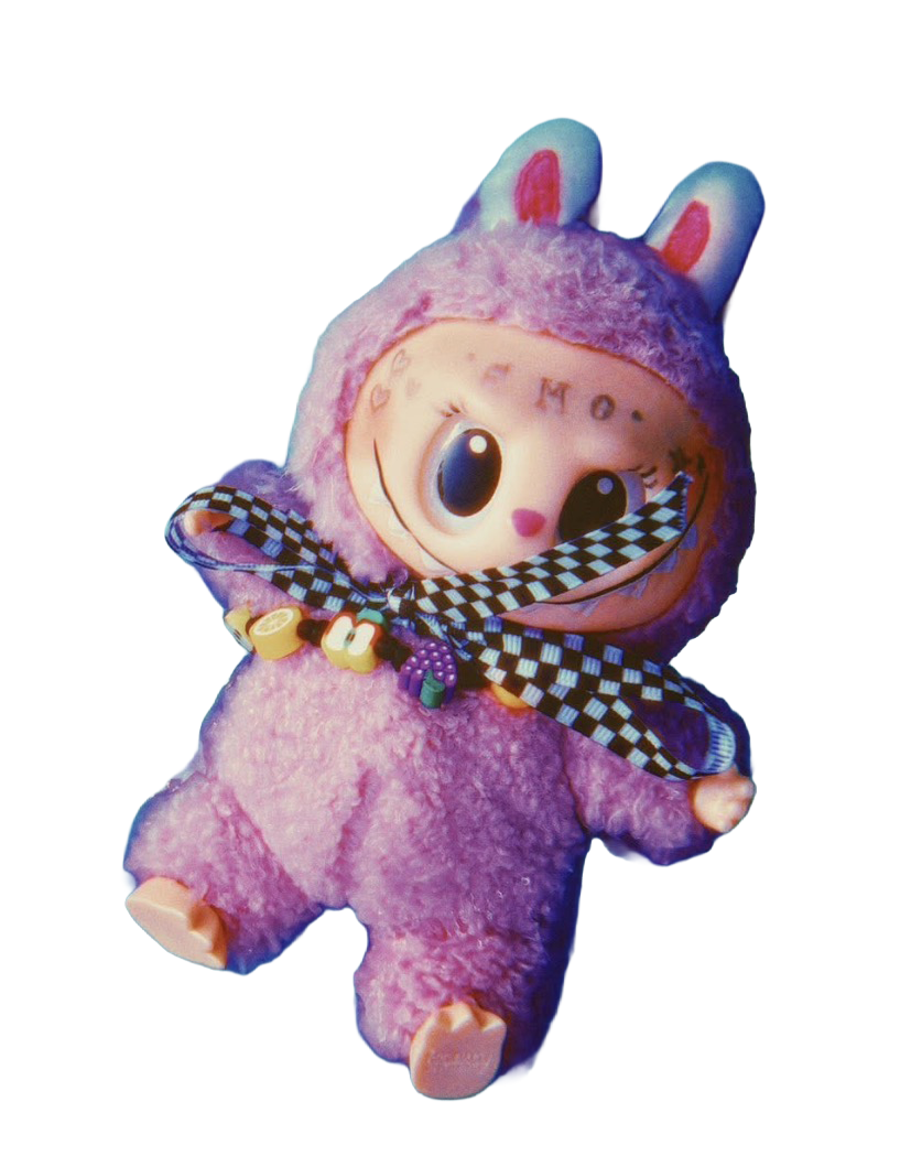 A plush toy with a cute cartoon face, large eyes, and a pink nose, wearing a purple fluffy costume with bunny ears and a checkered scarf.