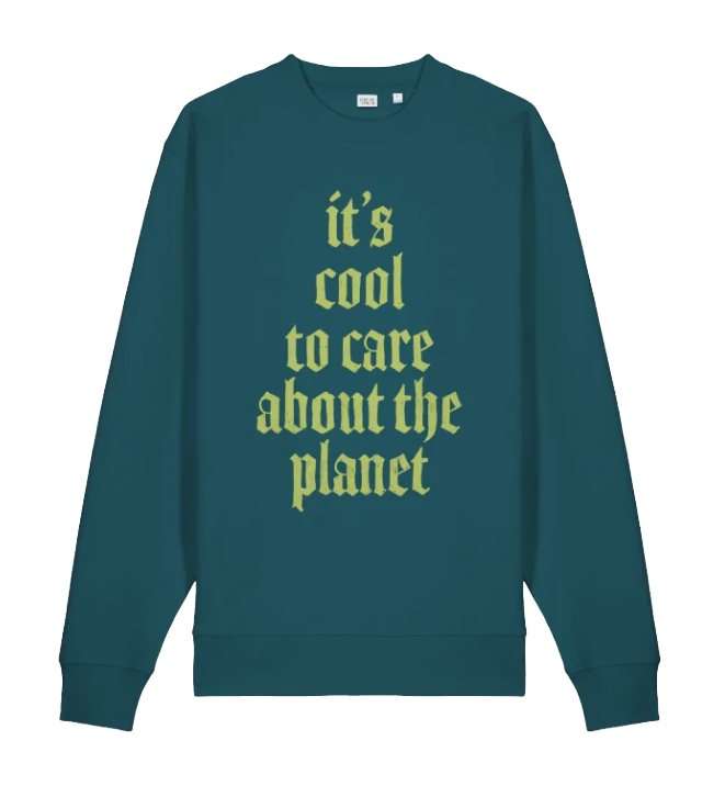A teal sweatshirt with the text "it's cool to care about the planet" written in yellow in a gothic font.